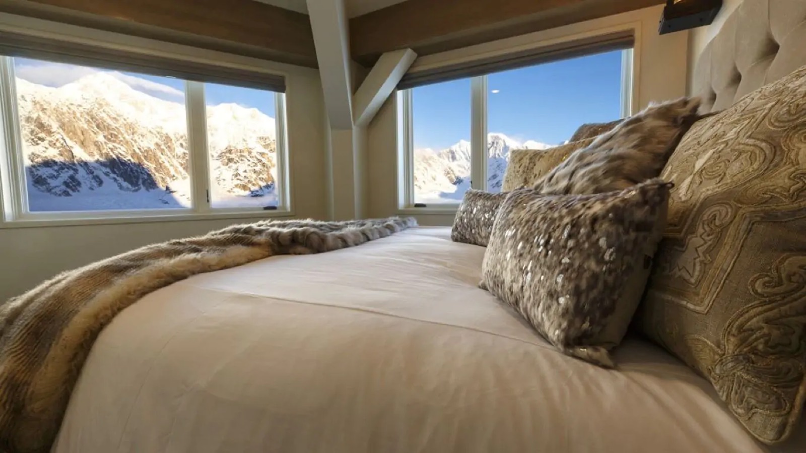 Corner bedroom, bed set beneath the windows