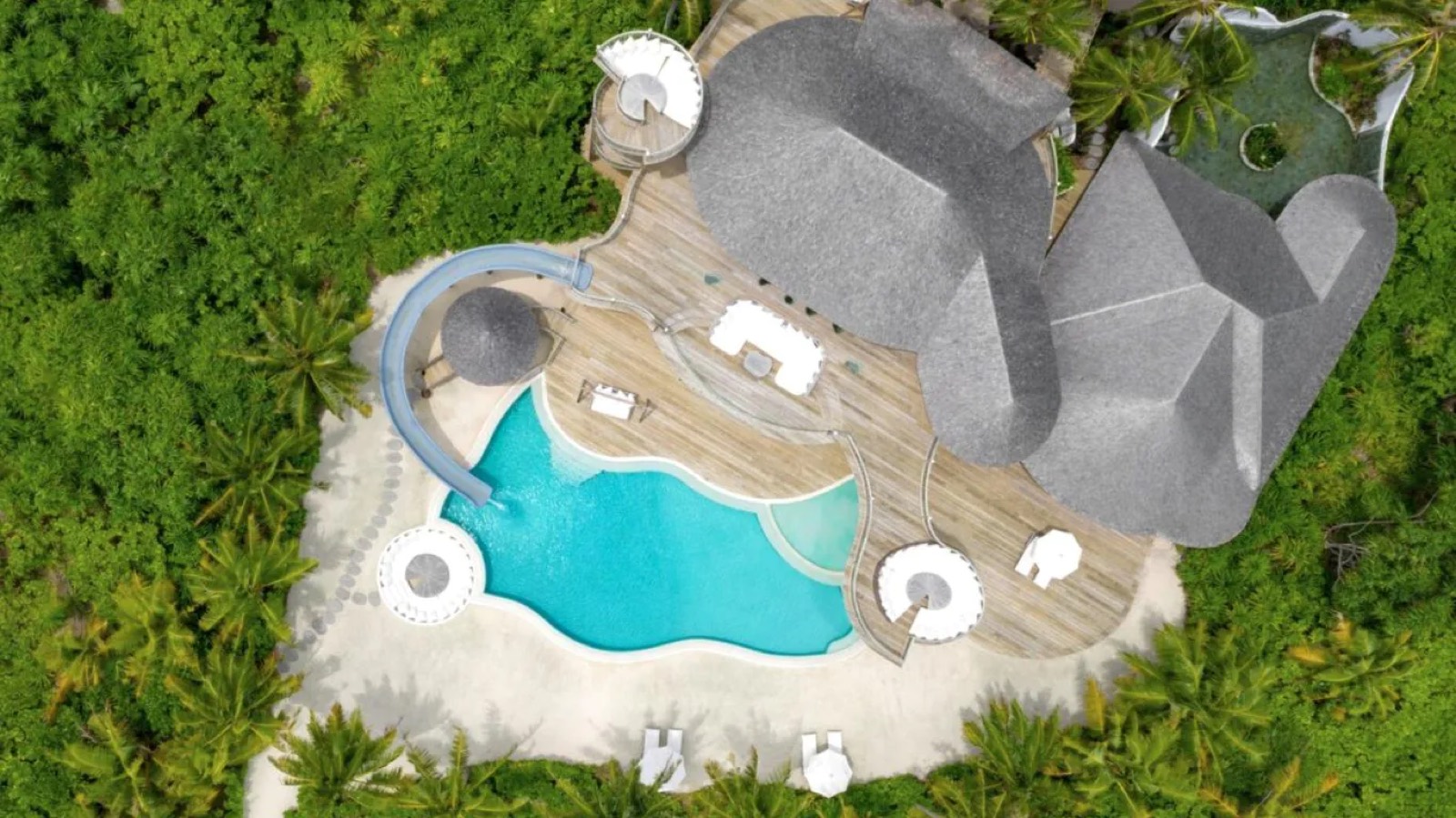 Looking straight down on pool and thatched roofs
