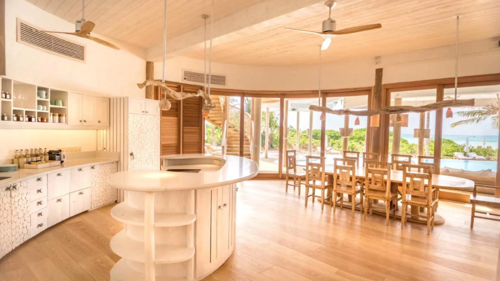Kitchen with curved island, dining table beyond