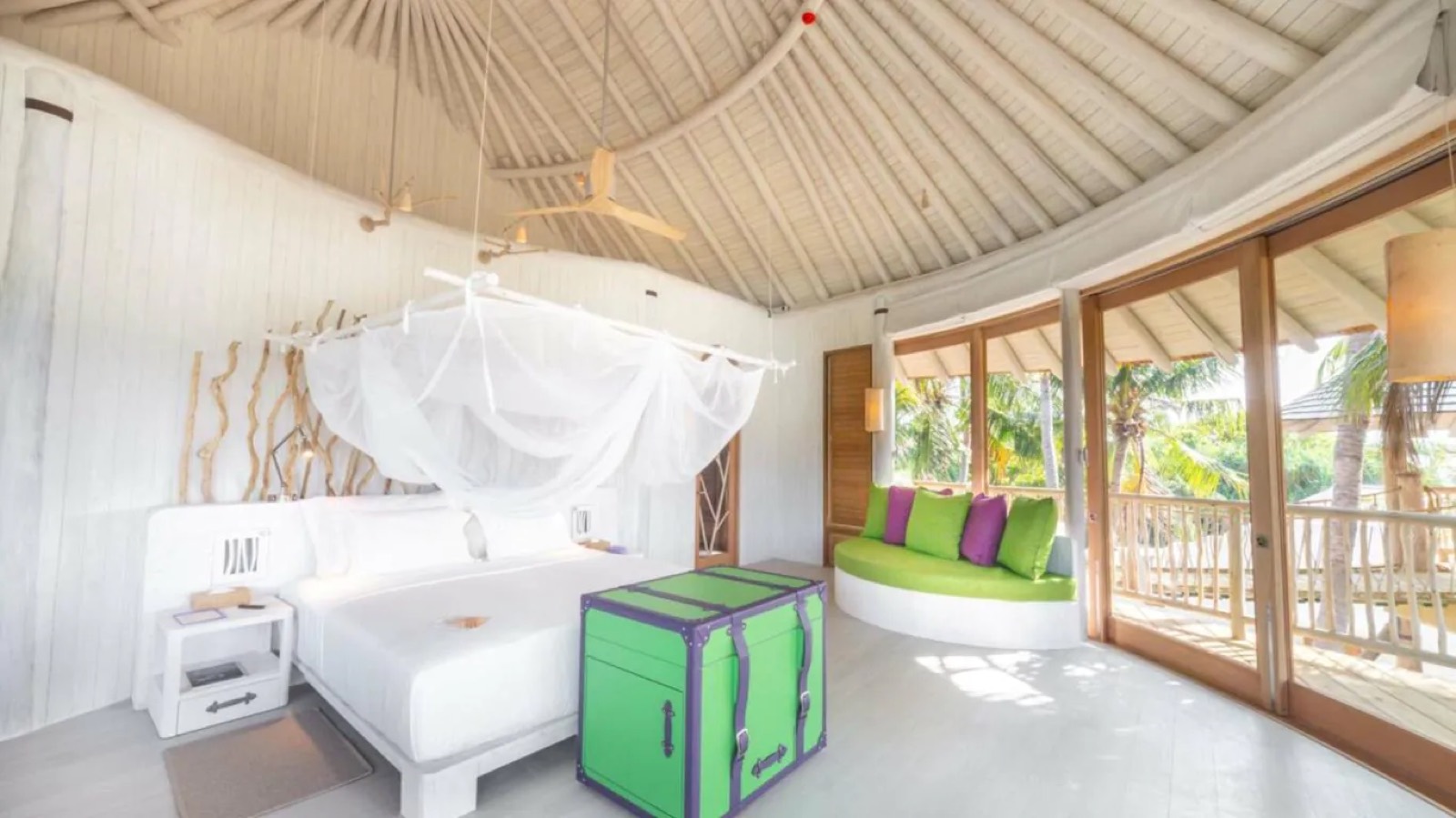 Bedroom under the thatched roof with canopied bed