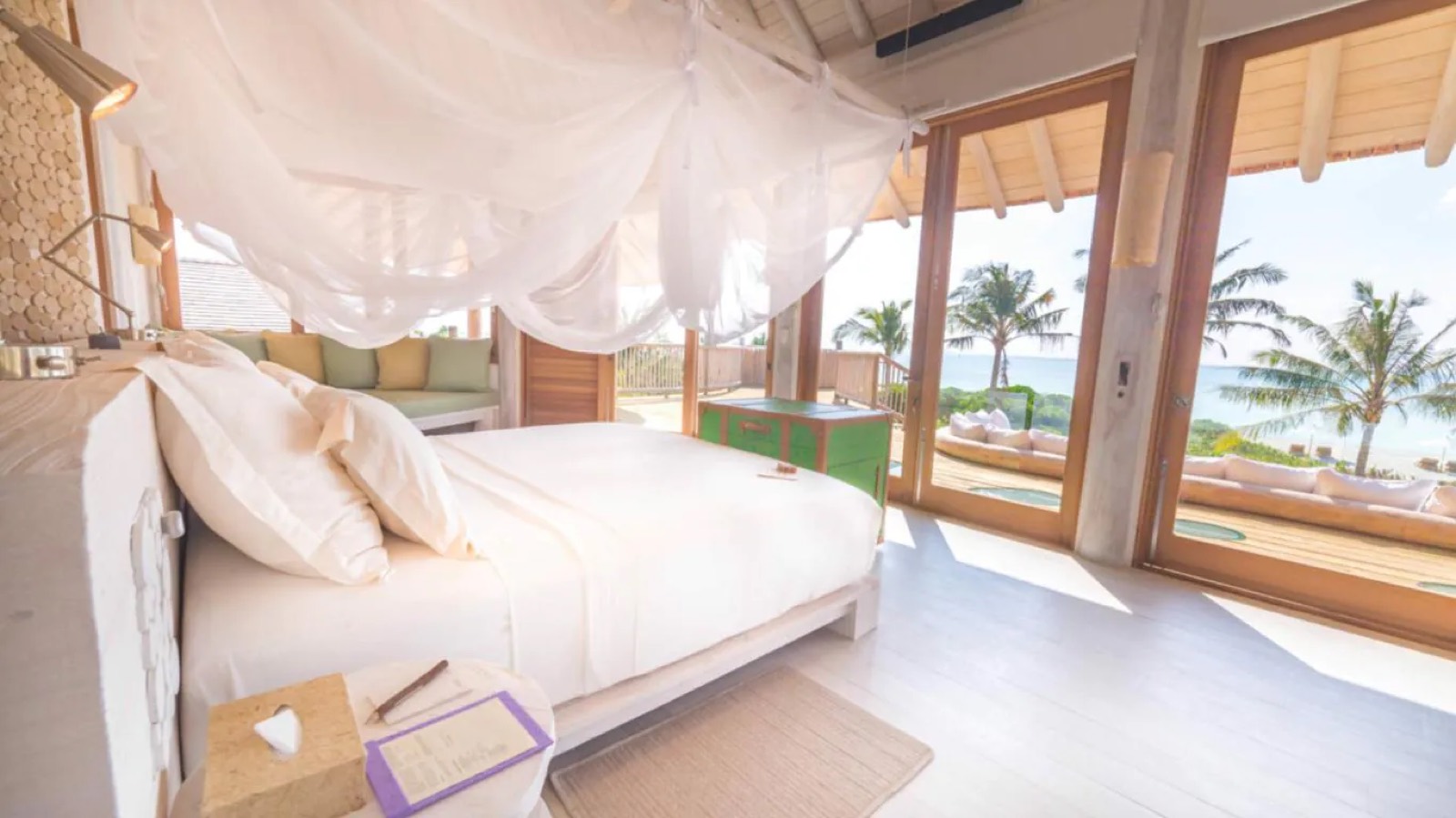 Bedroom opening onto the deck, sea beyond