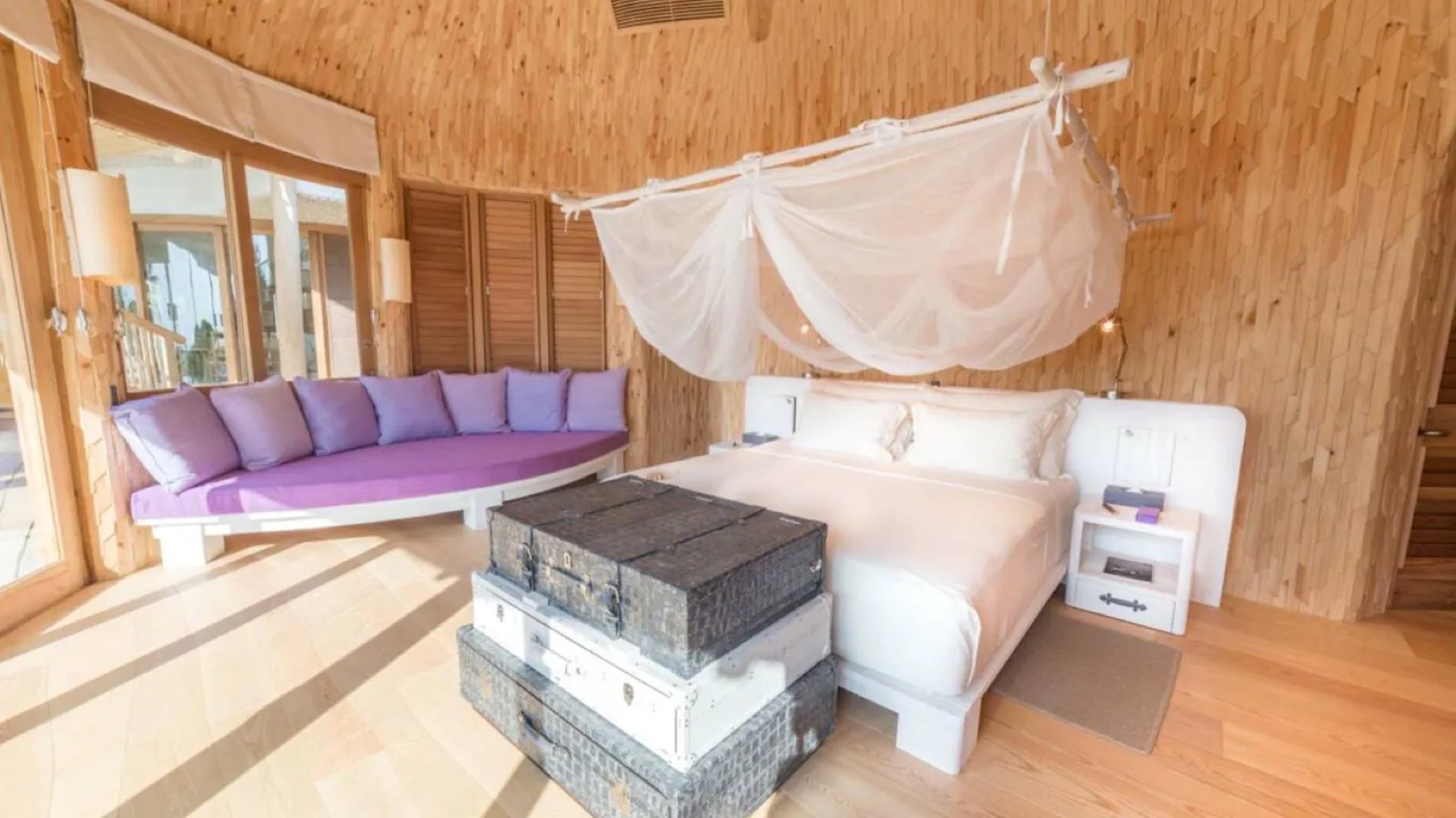 Timber-lined bedroom with purple daybed