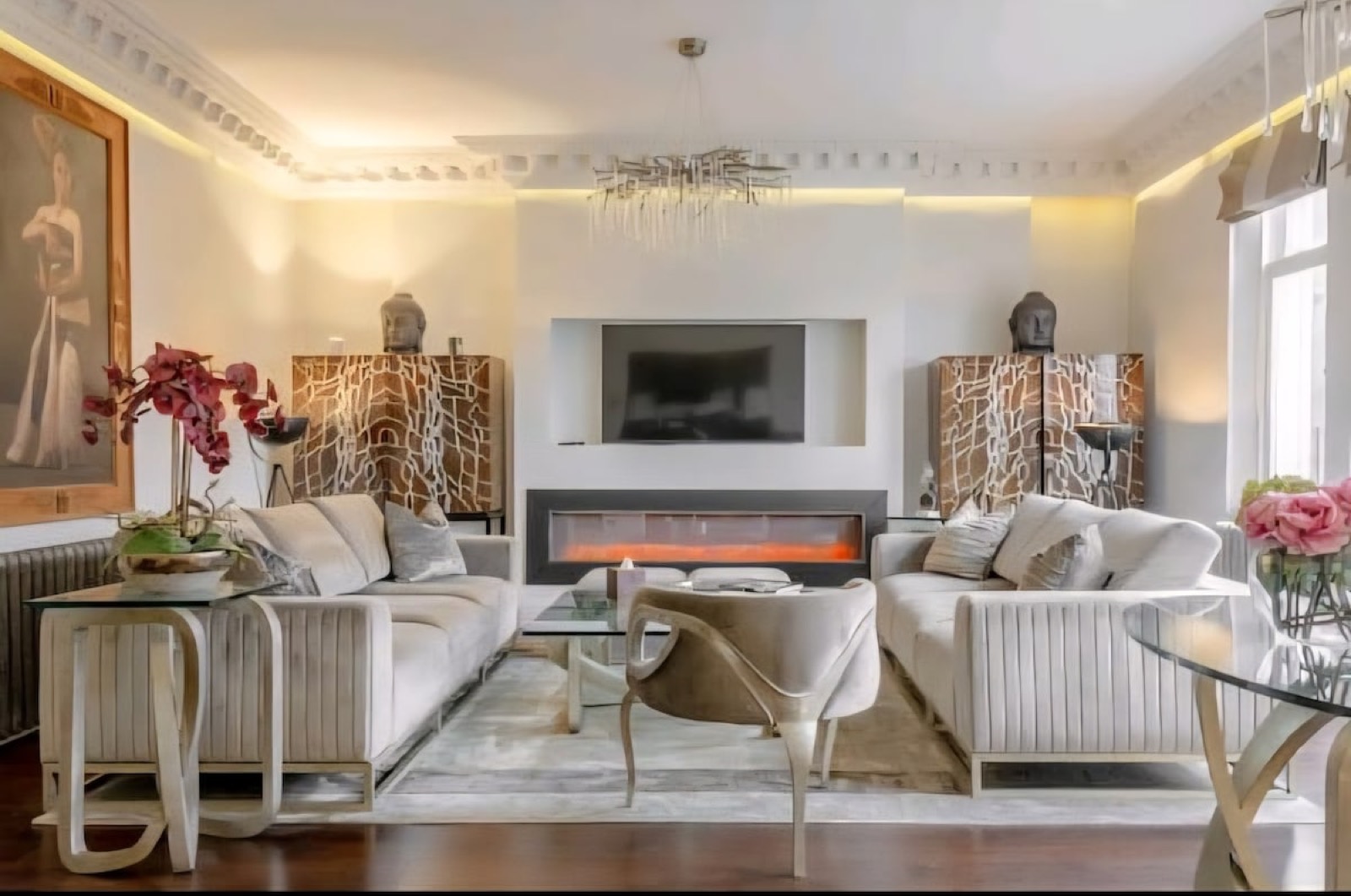 Sitting room with fire and framed portrait
