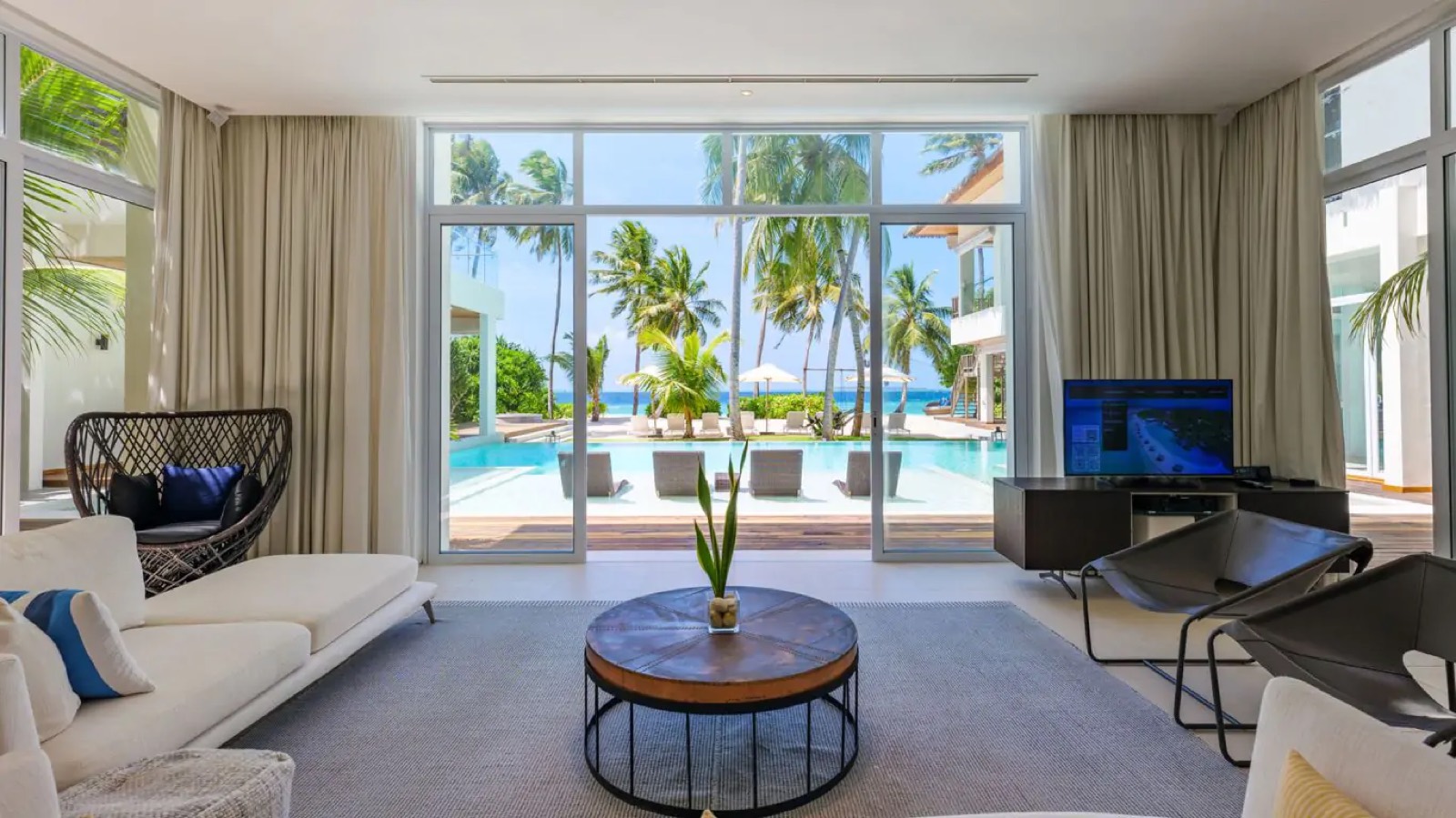 Sitting room with hanging chair and pool doors