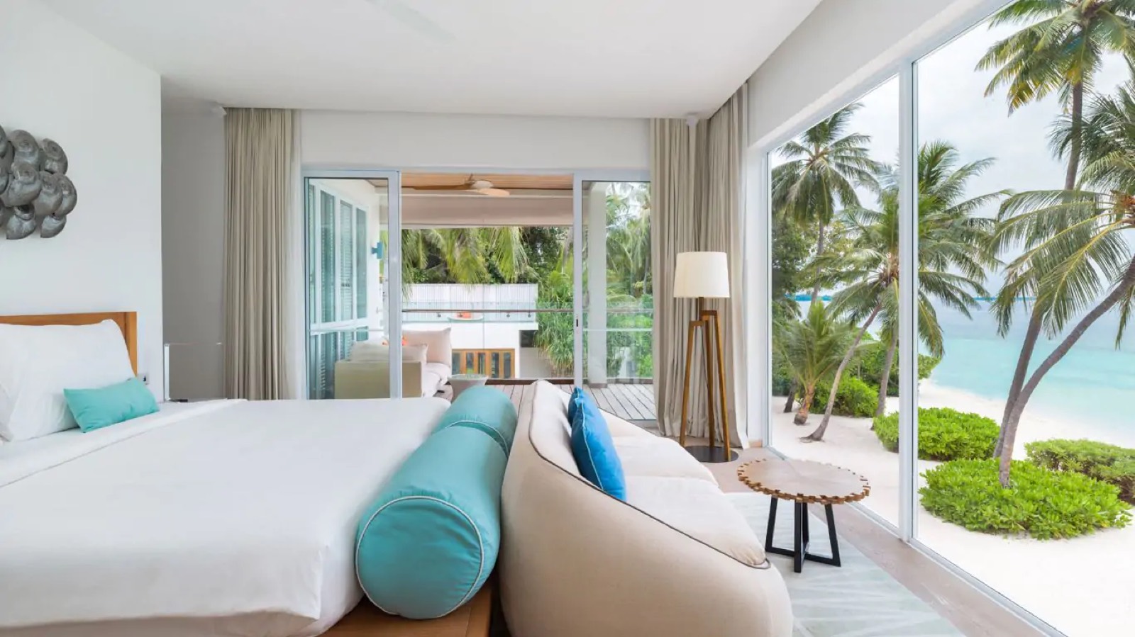 Bedroom with sofa facing the beach