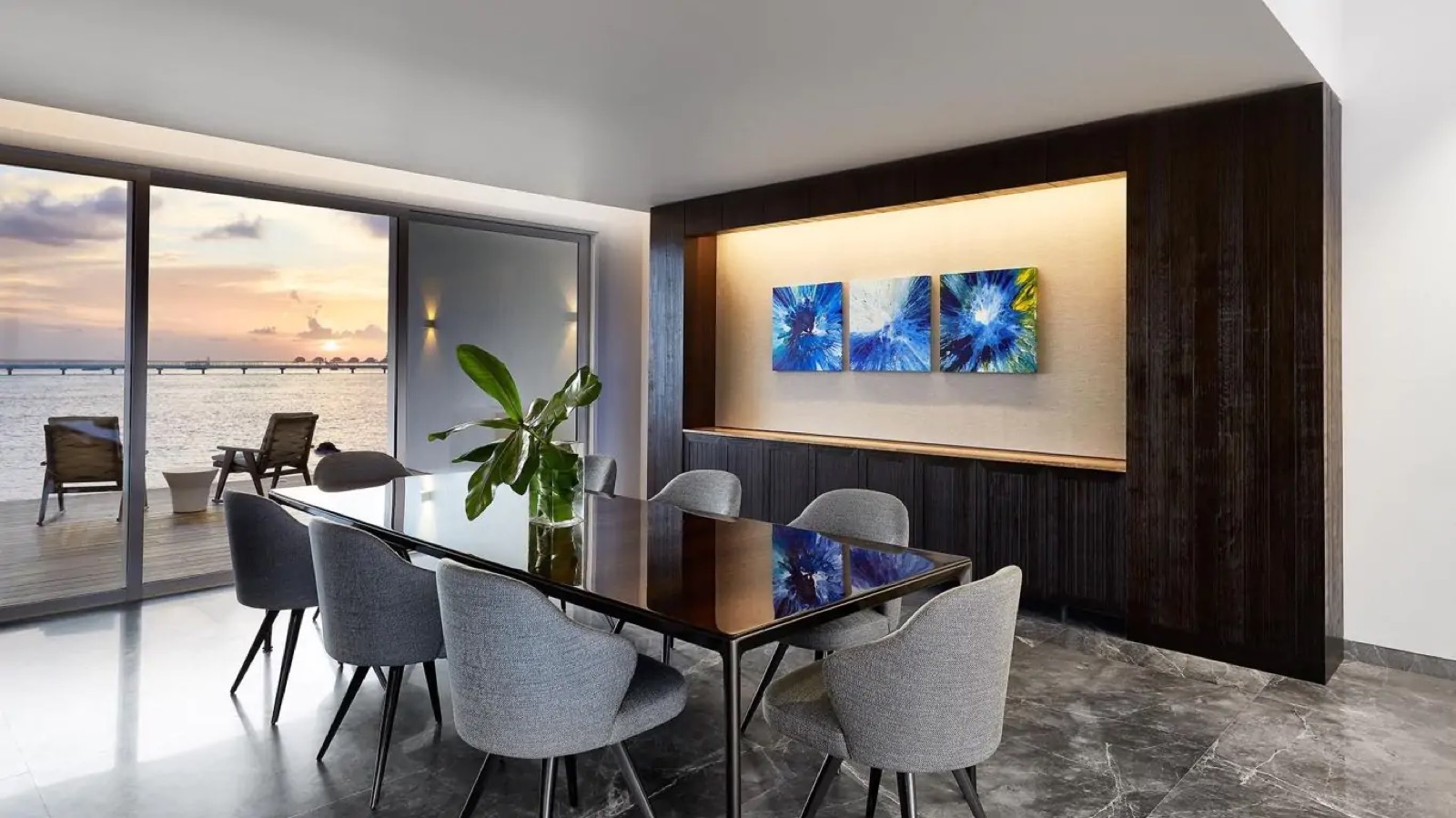 Dining room with artwork and sunset deck