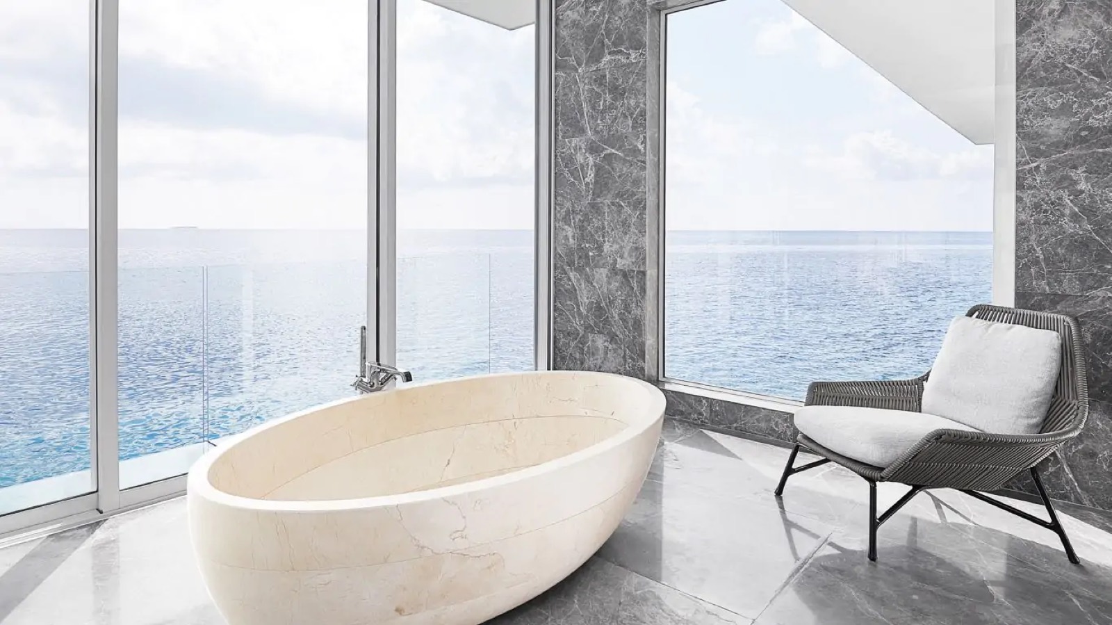 Freestanding stone bath above the water