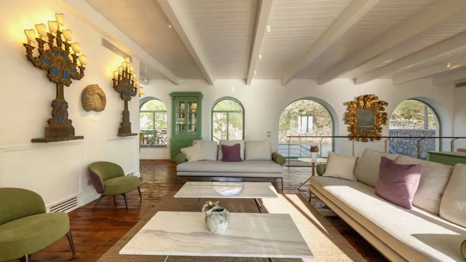 Sitting area with gilded candelabra sconces