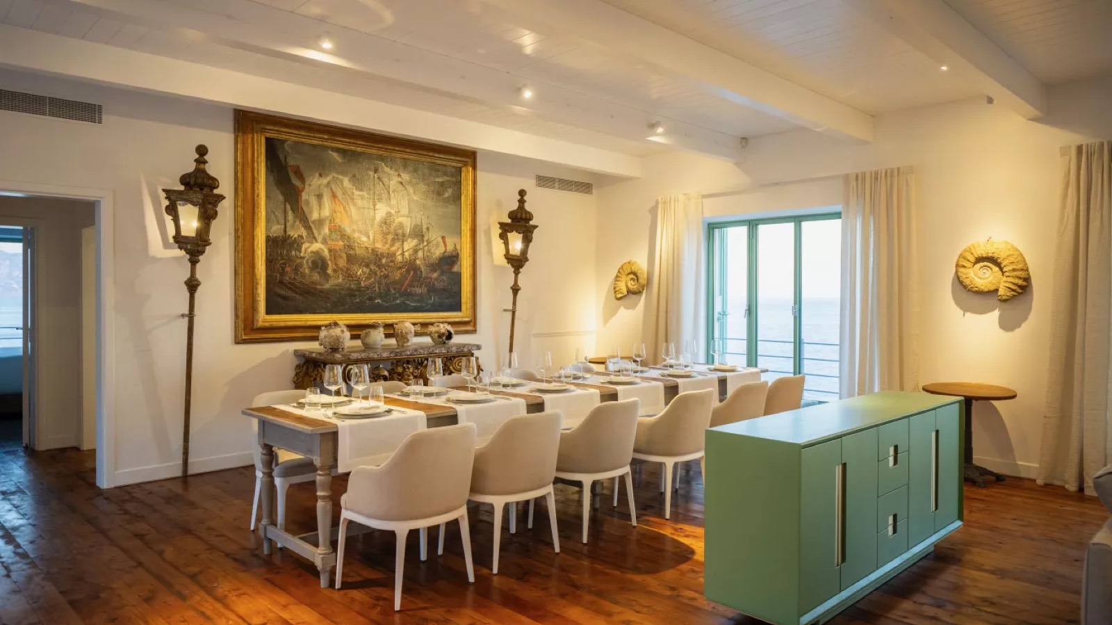 Dining table for twelve beneath an antique painting