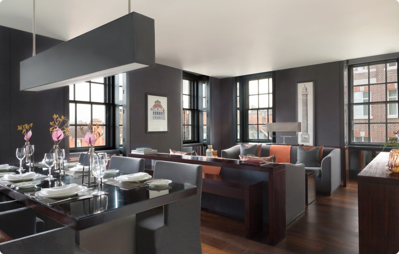 Dining table set beneath the long pendant