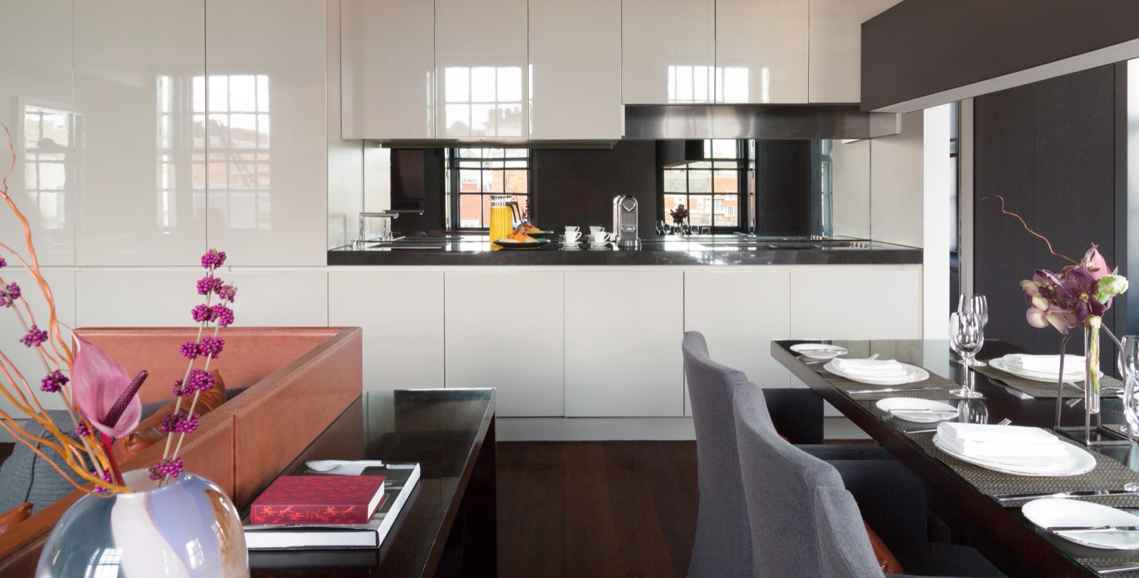 Dining table laid beside the open kitchen