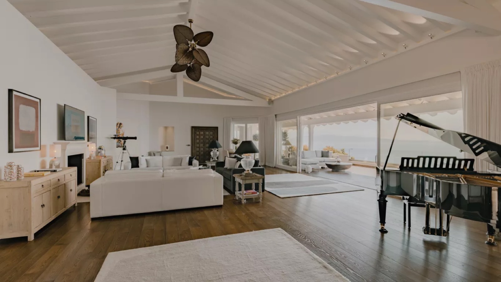 Vaulted lounge with grand piano and fireplace