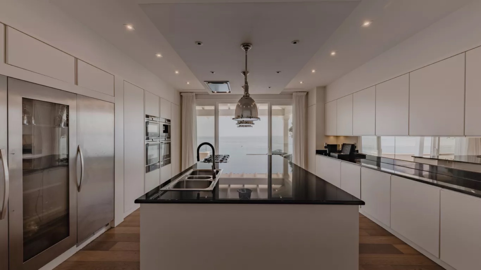 Chef's kitchen with island and sea beyond