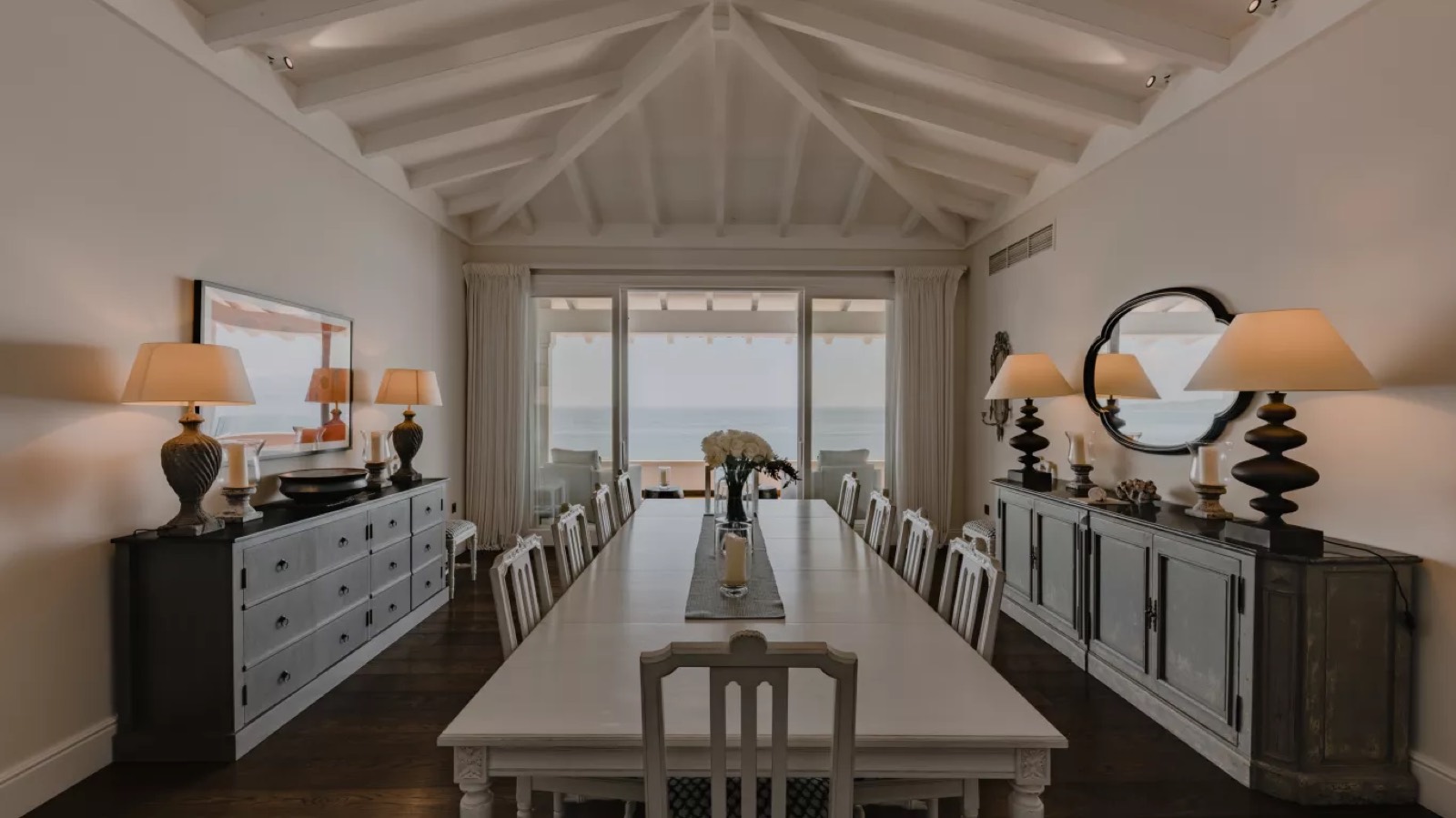 Long dining table beneath the beamed ceiling