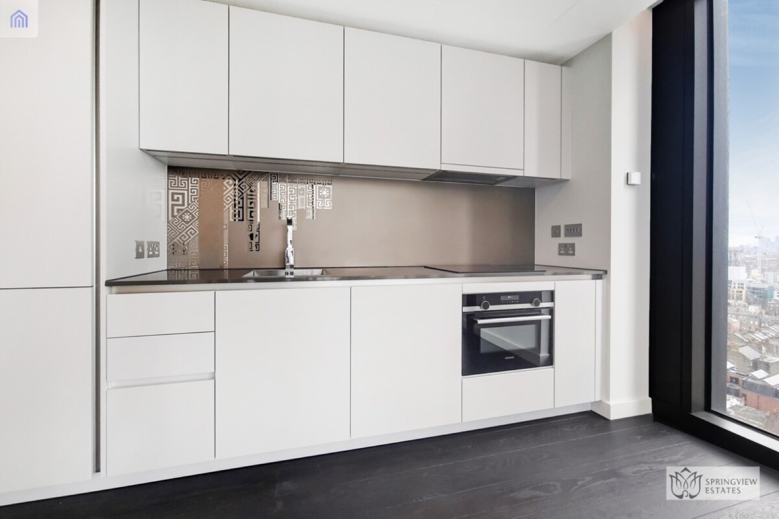 Kitchen with bronze Greek-key splashback