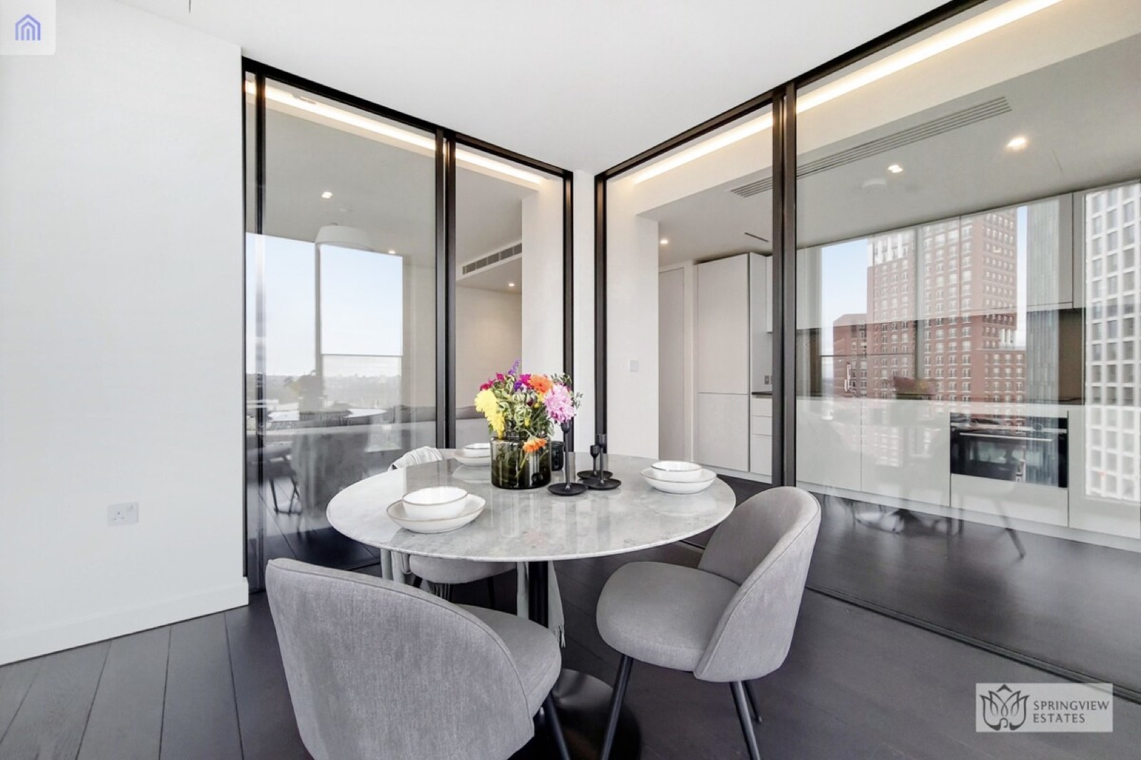 Dining table framed by glass partitions