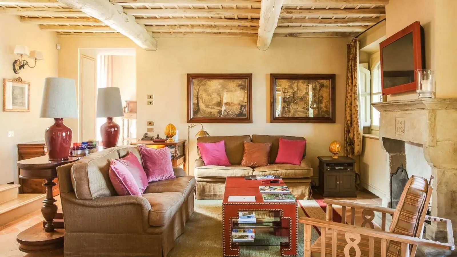 Sitting room with sofas beneath beamed ceiling