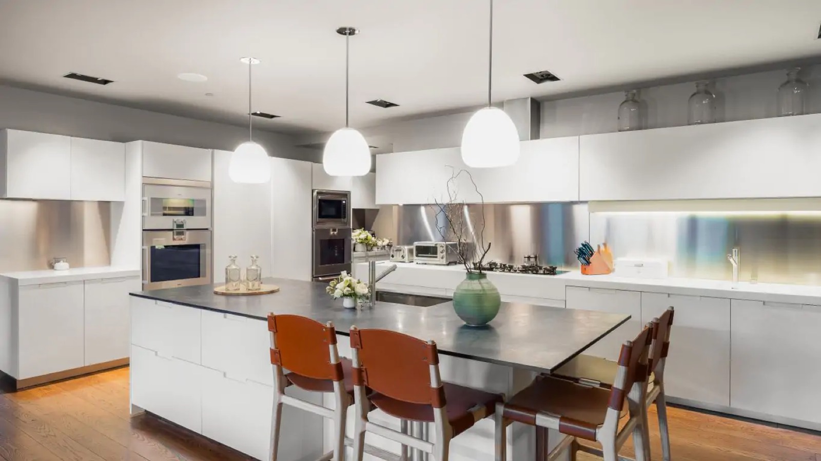 Kitchen island with seating and steel splashback