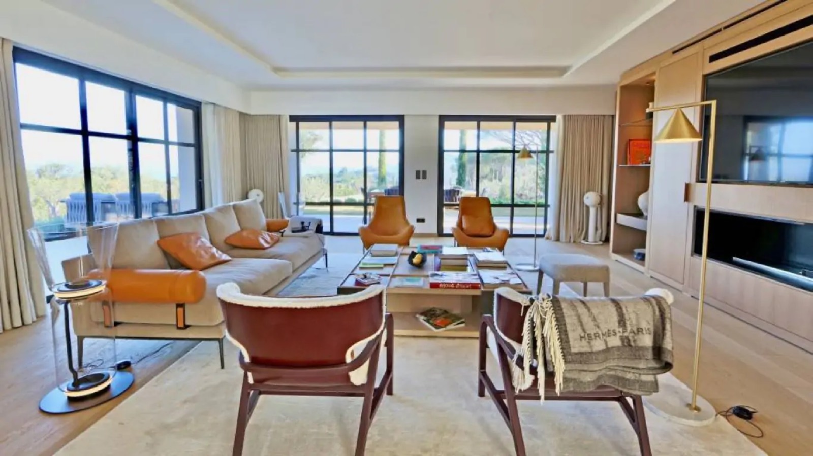Living room in beige with tan leather chairs