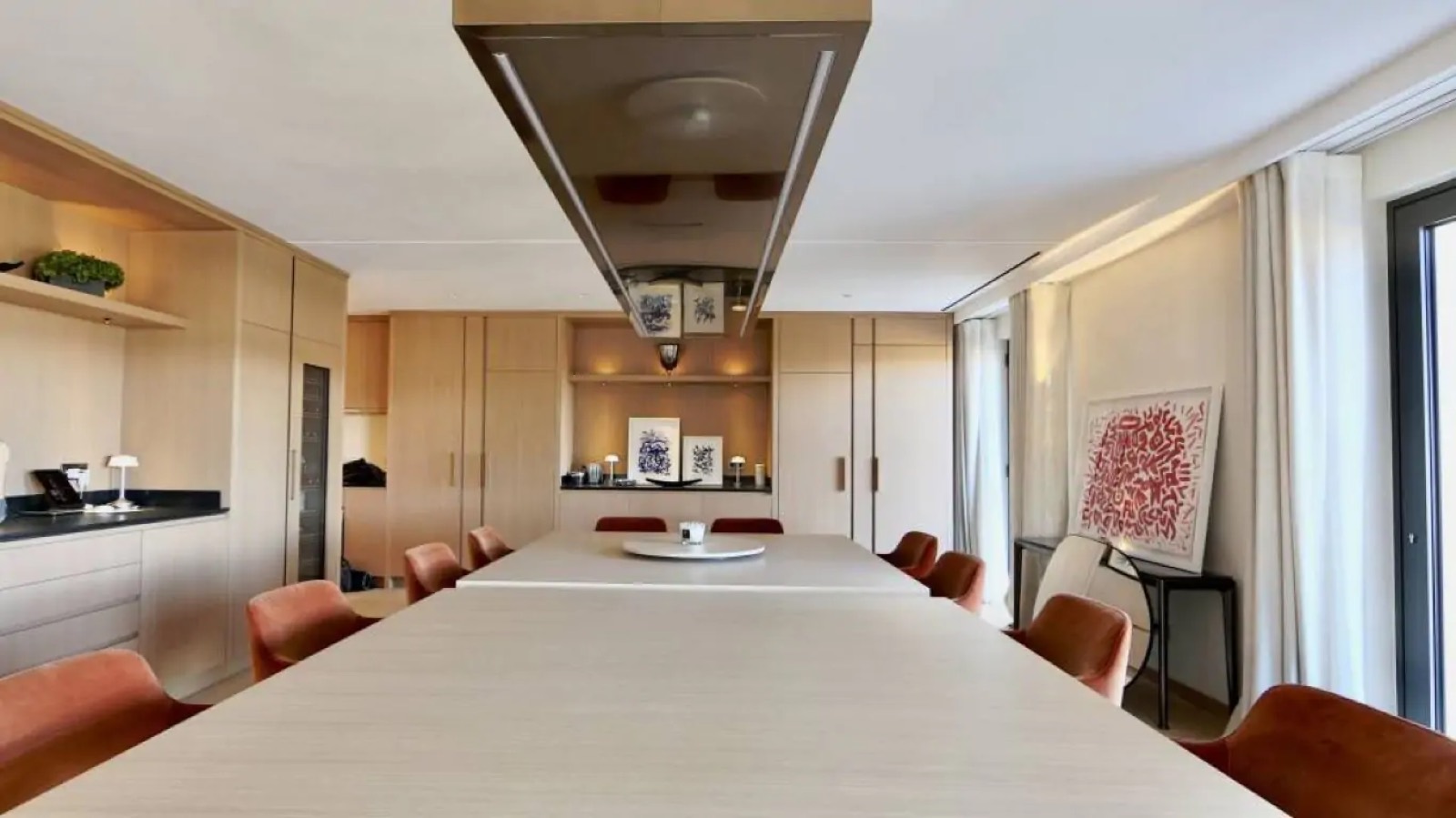 Long dining table beside the kitchen counter