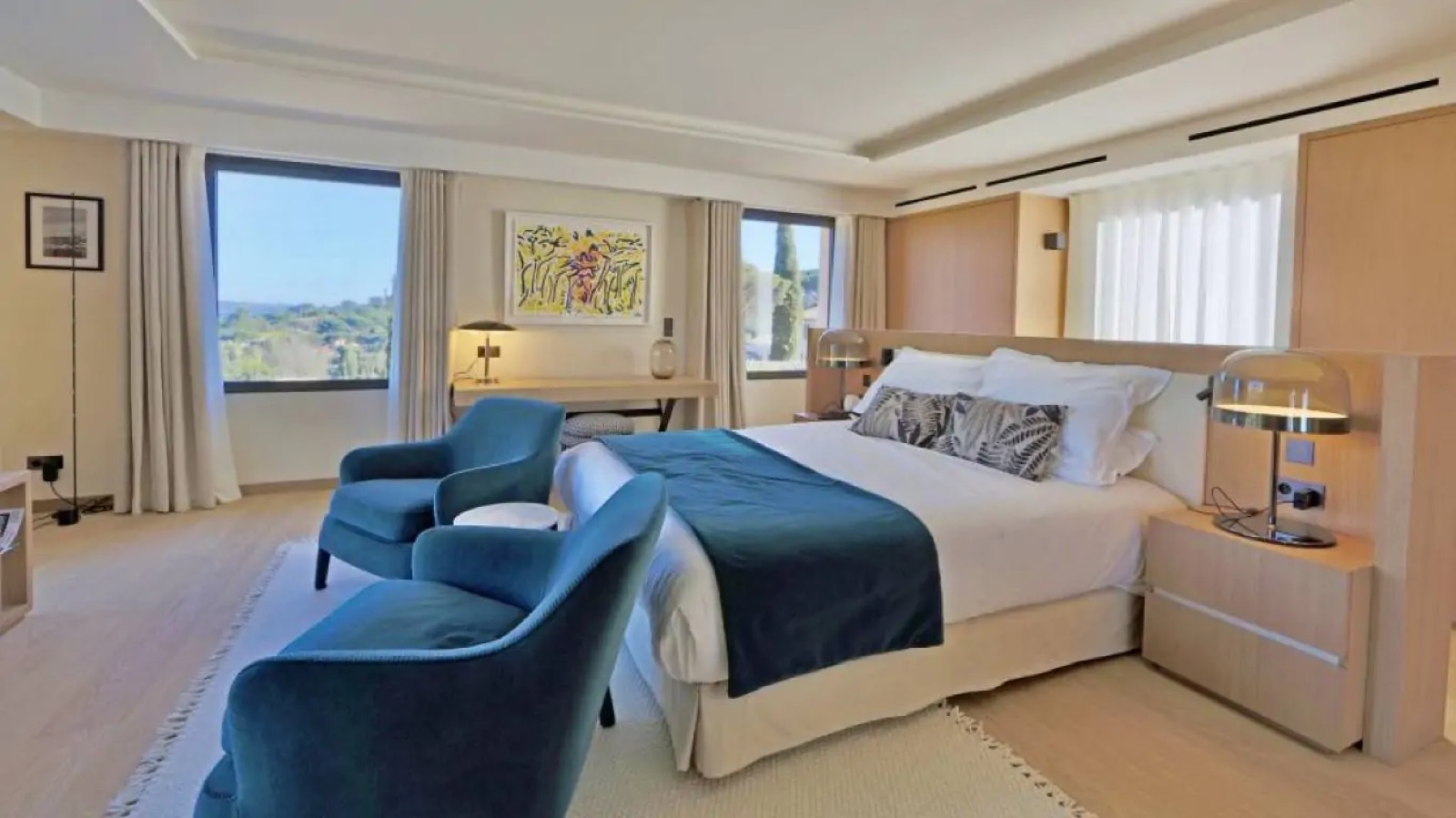 Bedroom in teal with wooded hillside views