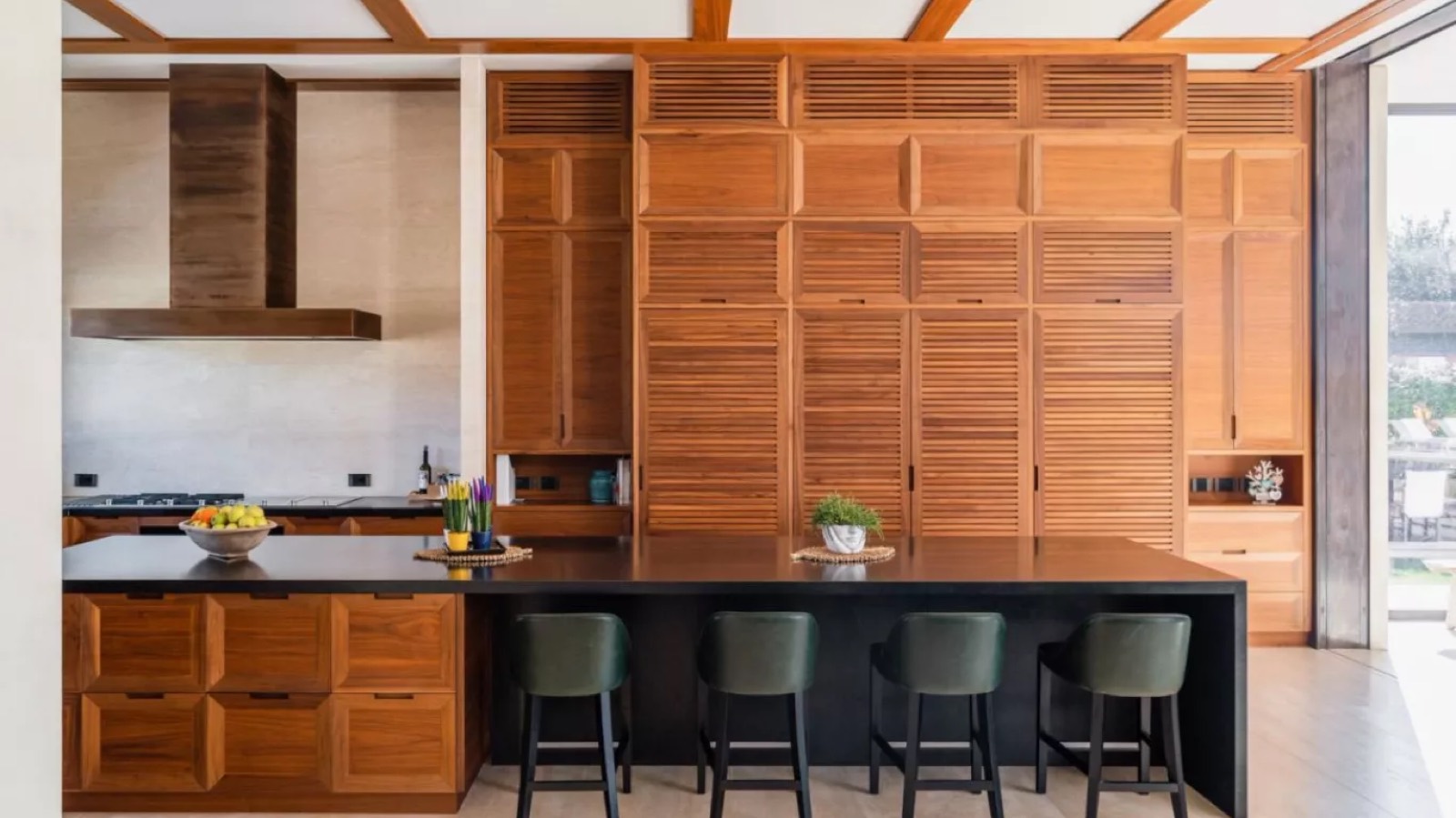 Kitchen island with stools and louvred cabinetry