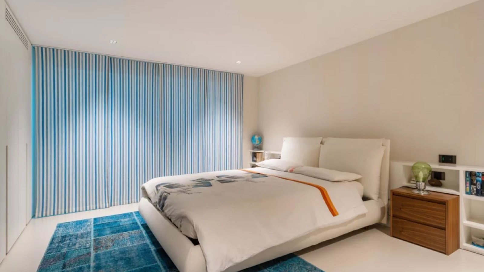 Bedroom with blue striped curtains