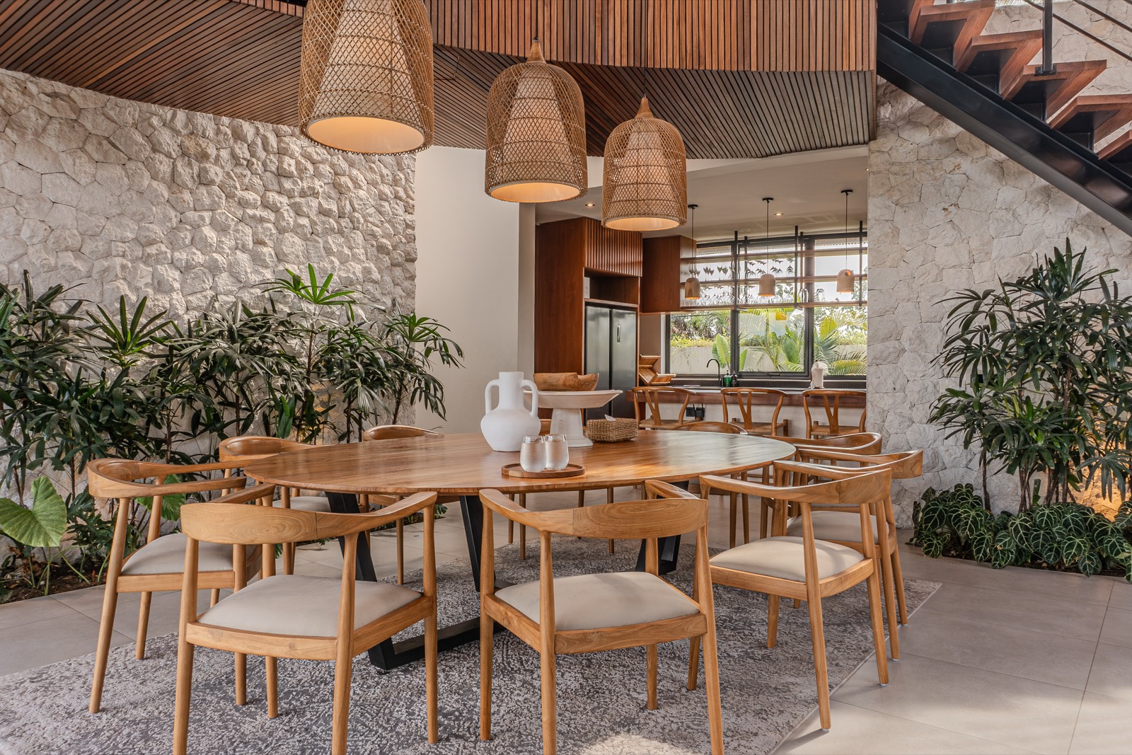 Dining table beneath woven rattan shades