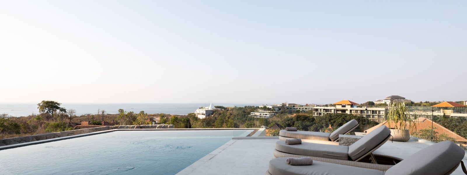 Sun loungers beside the infinity pool
