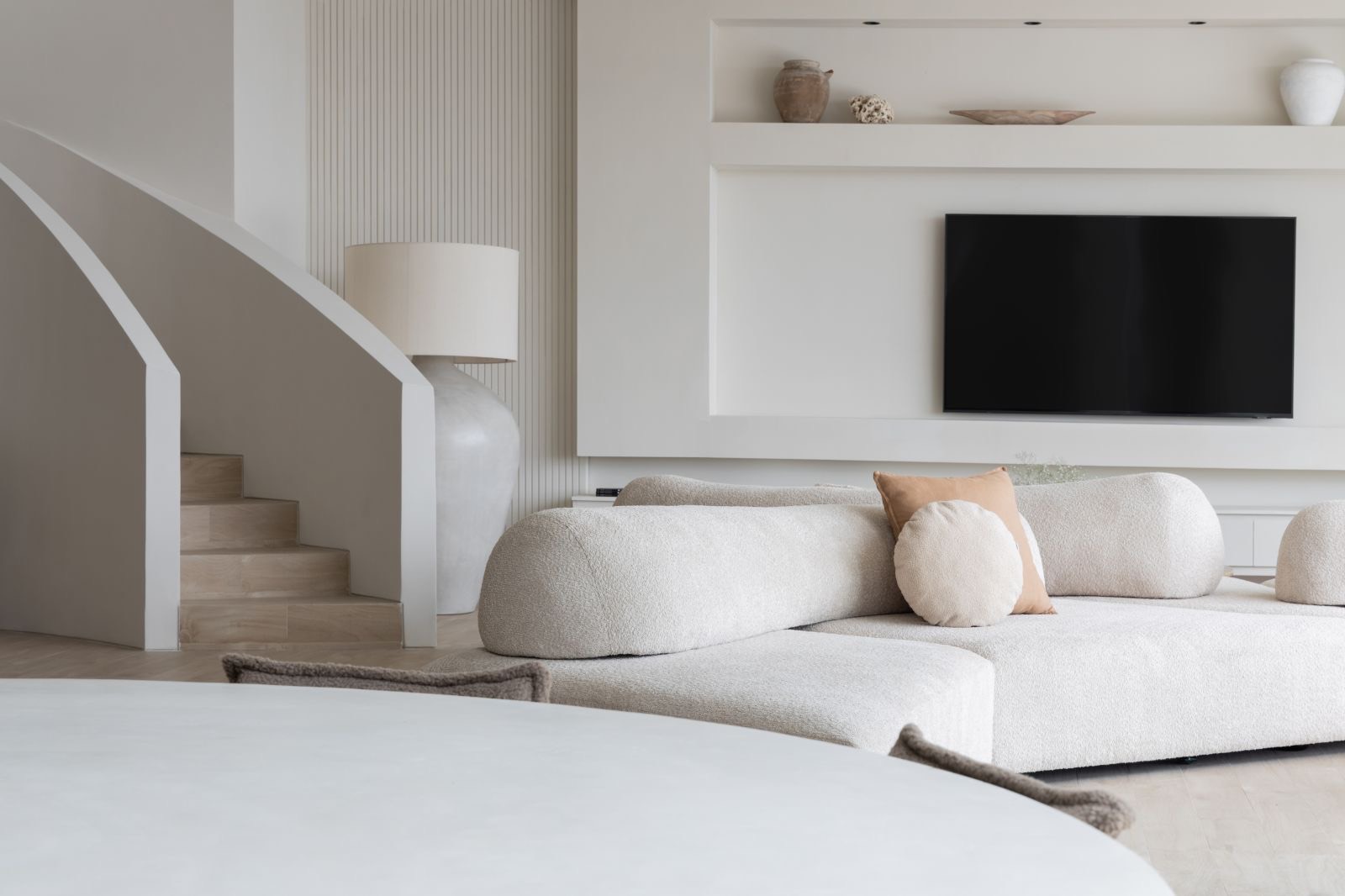 Sofa and media wall beside the staircase
