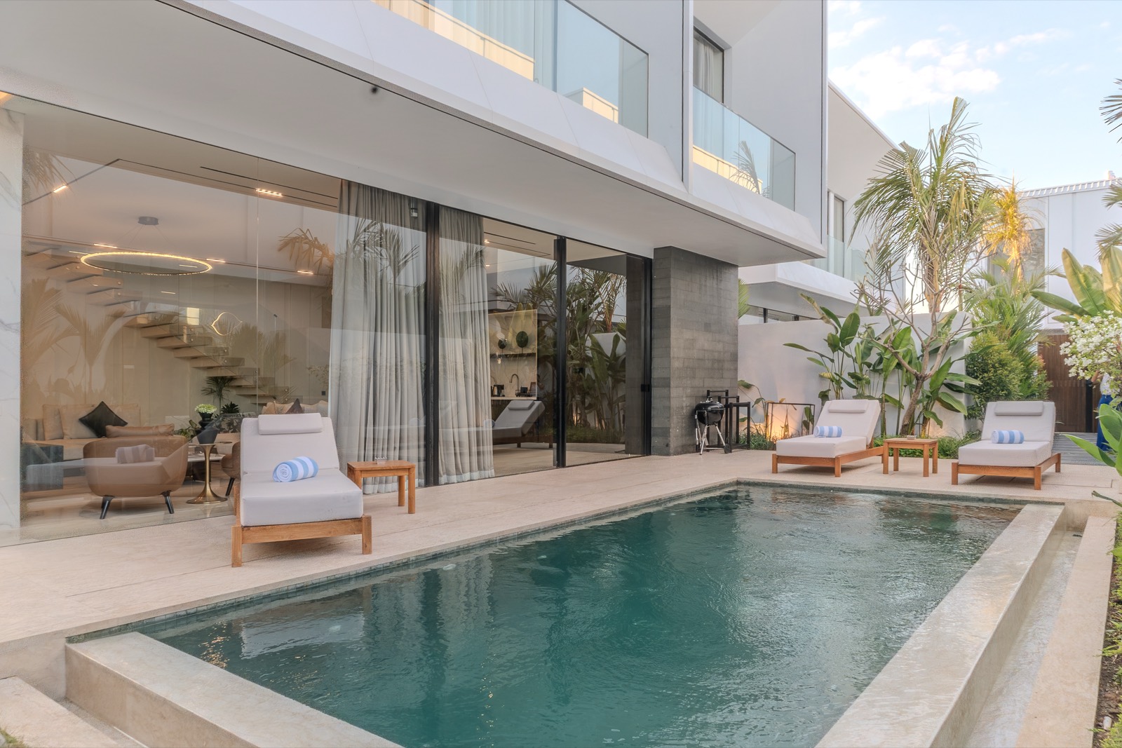 Sliding doors opening from the lounge to the pool