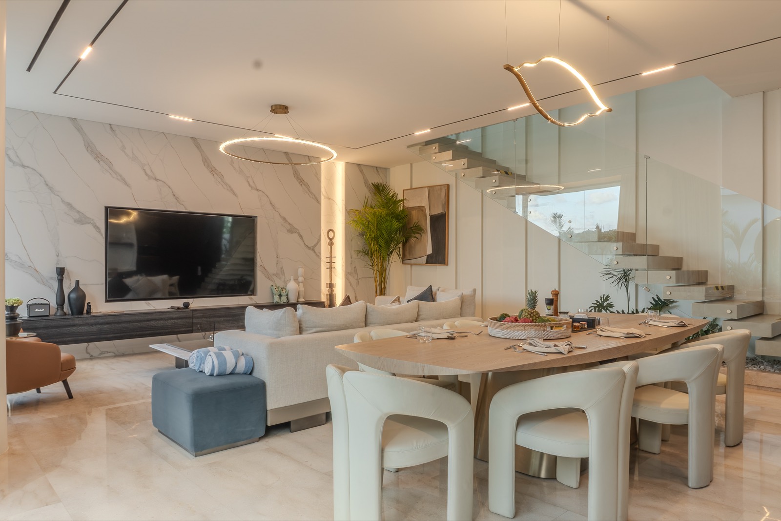 Open-plan living and dining with marble media wall