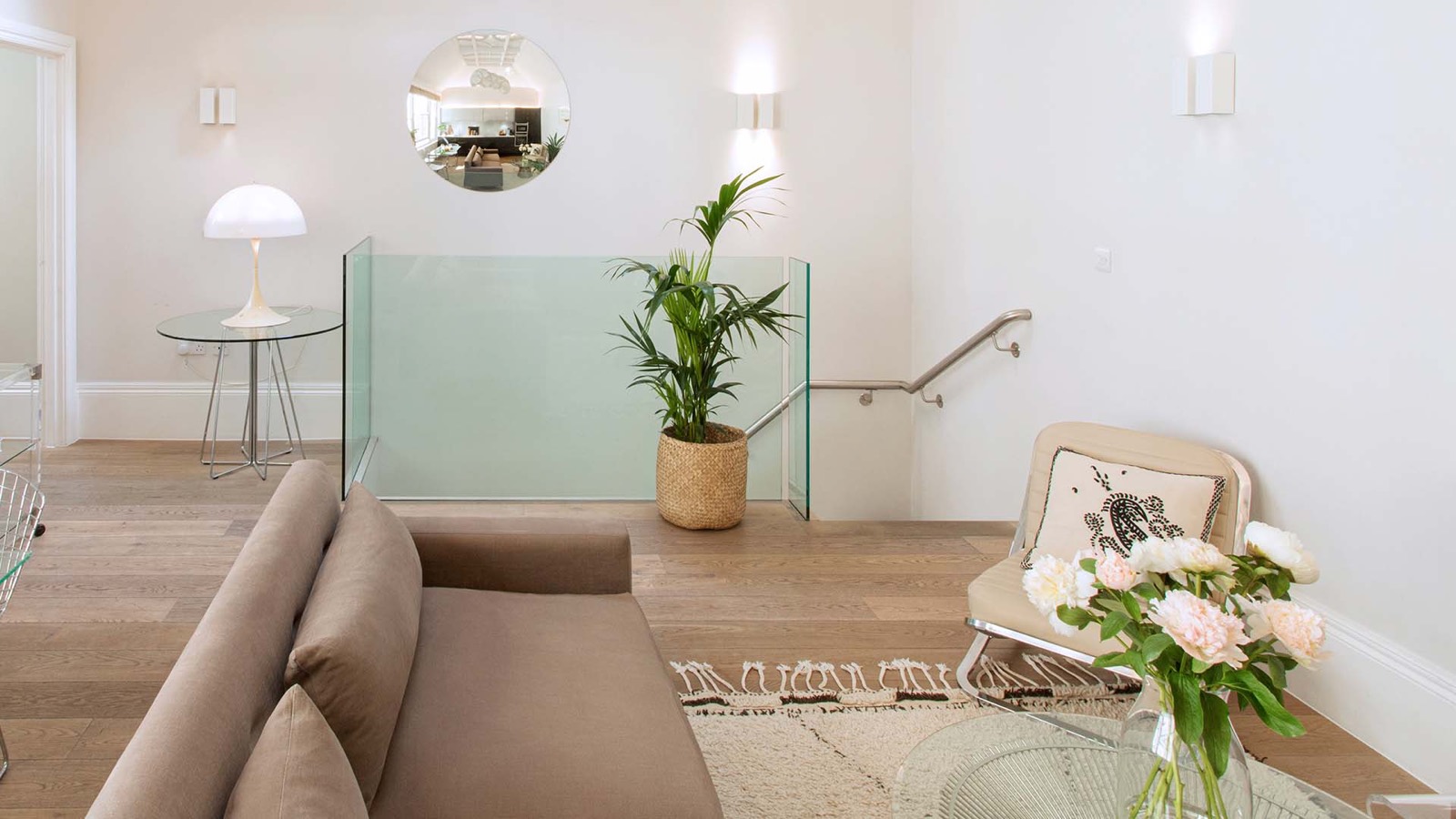 Sitting area beside the glass stair balustrade