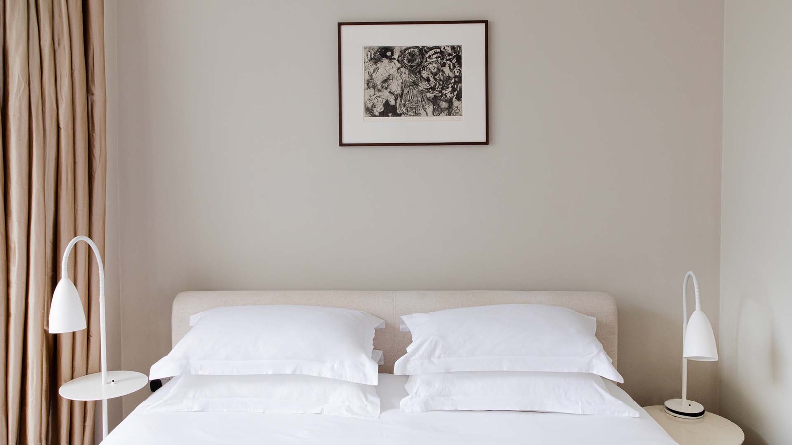 Bedroom with framed etching above the bed