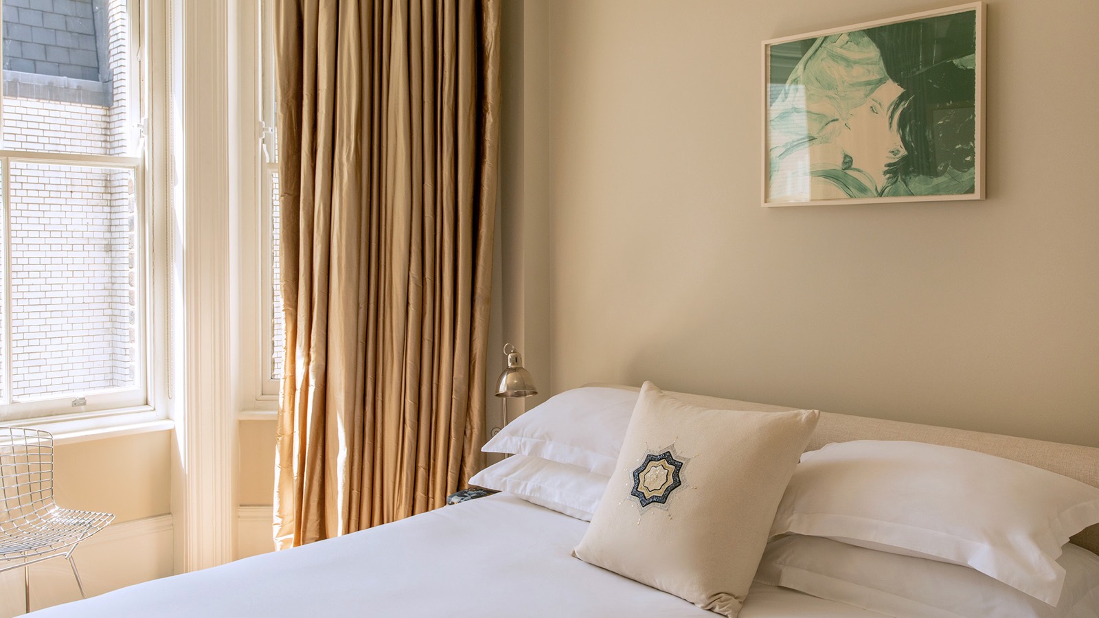 Bedroom with white linen and silk curtains