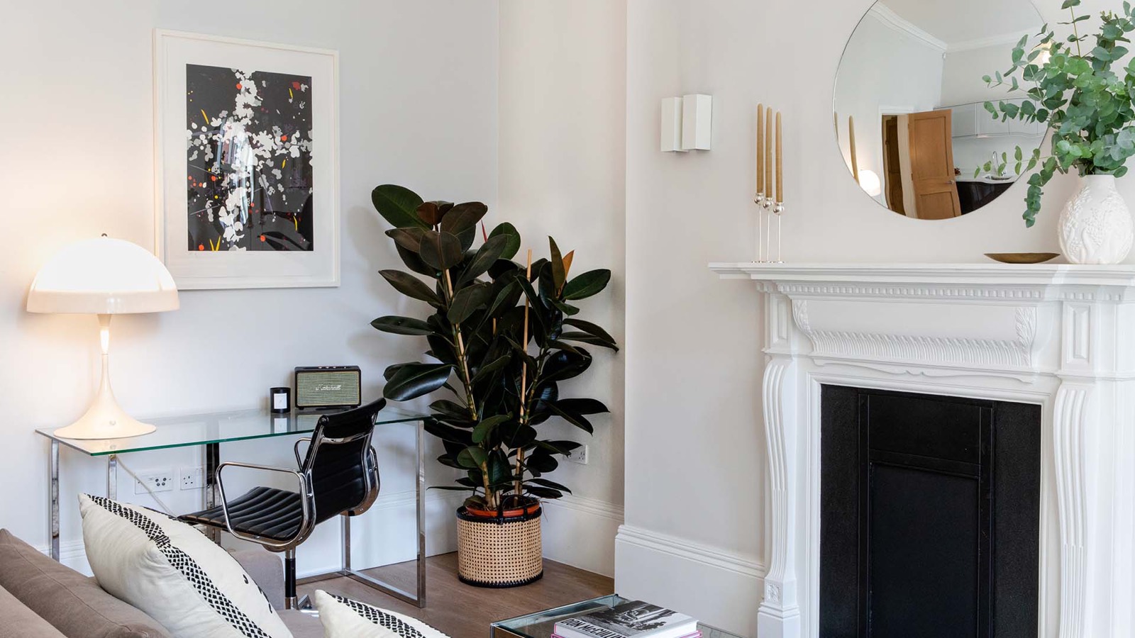Glass desk beside the fireplace