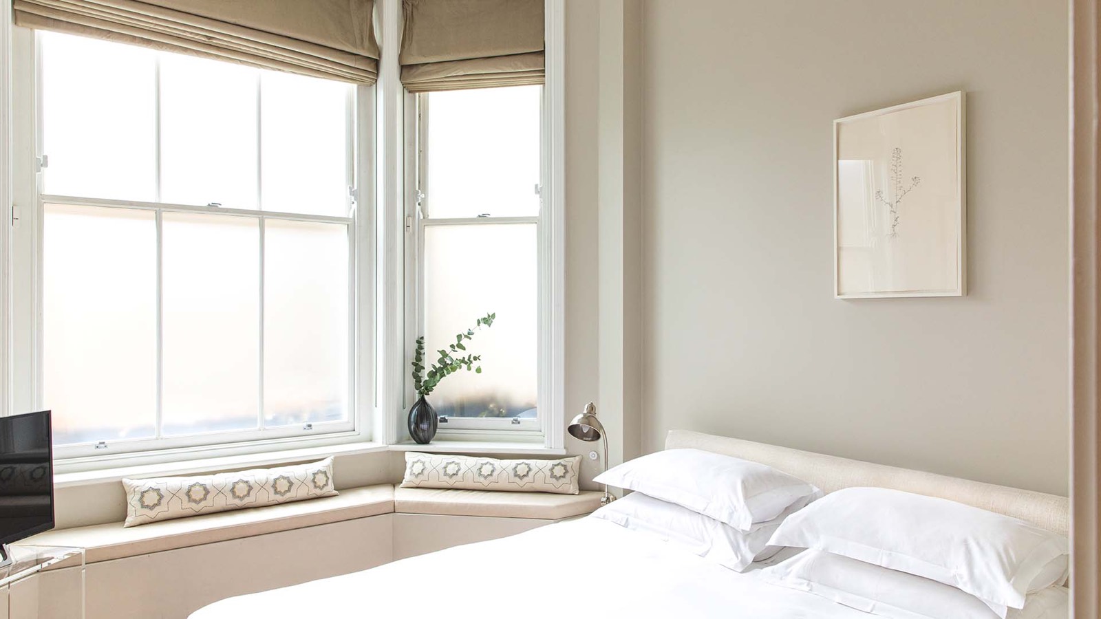 Cushioned seat in the bedroom bay window