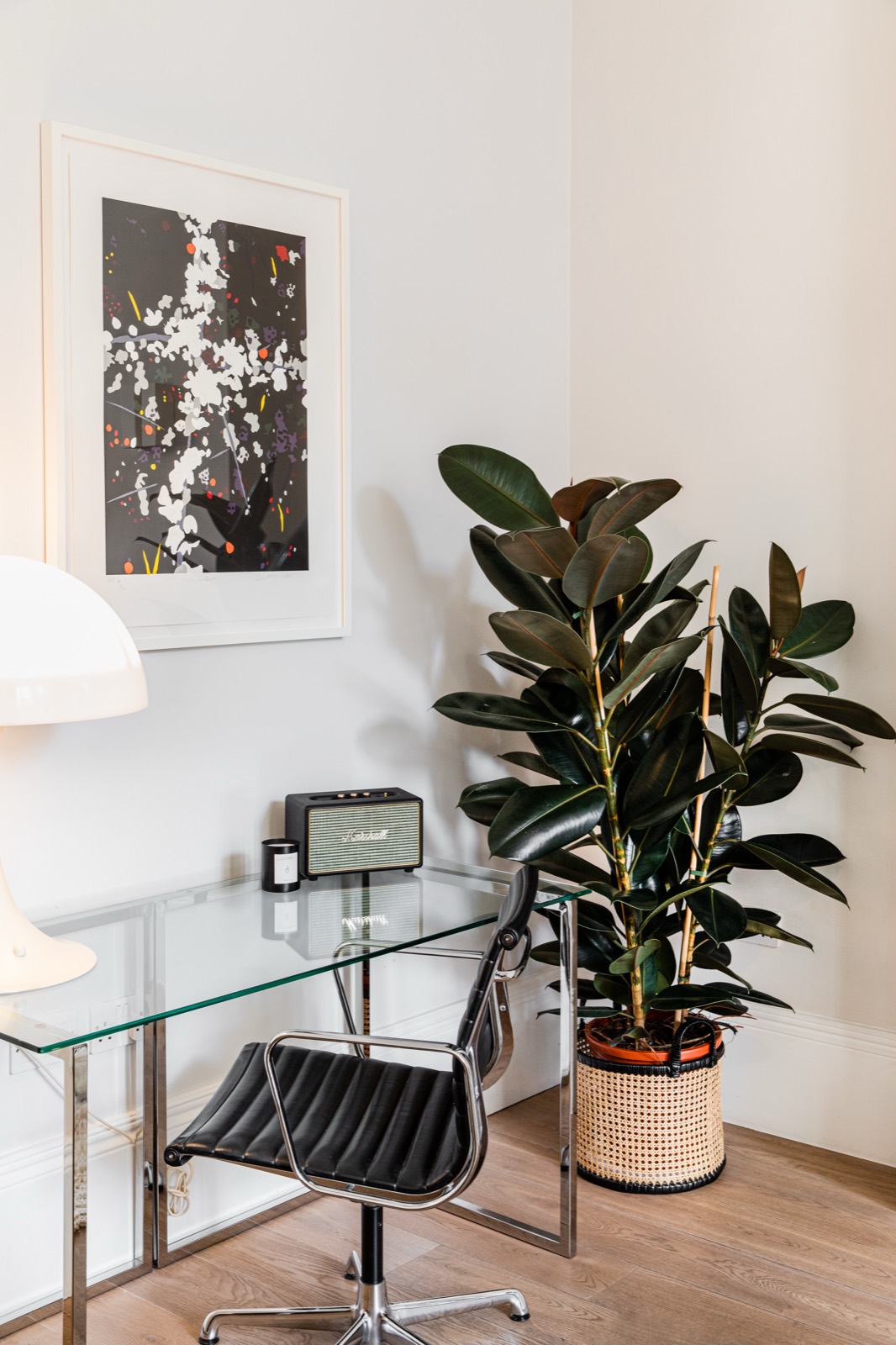 Writing desk with print and rubber plant