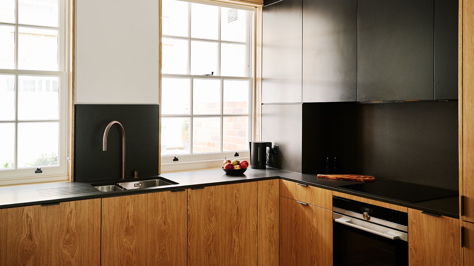 Oak kitchen with black stone worktops