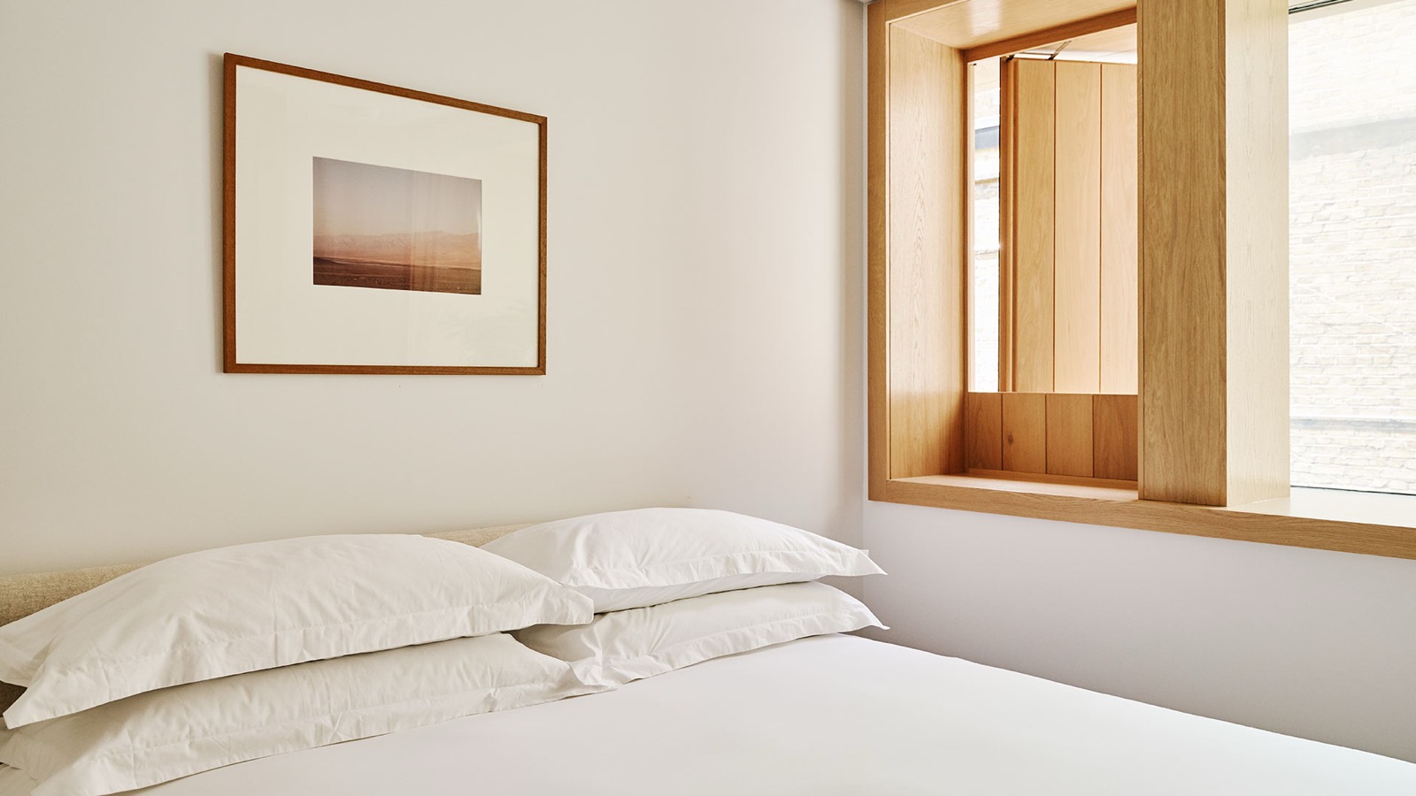 Bedroom with framed photograph above the bed
