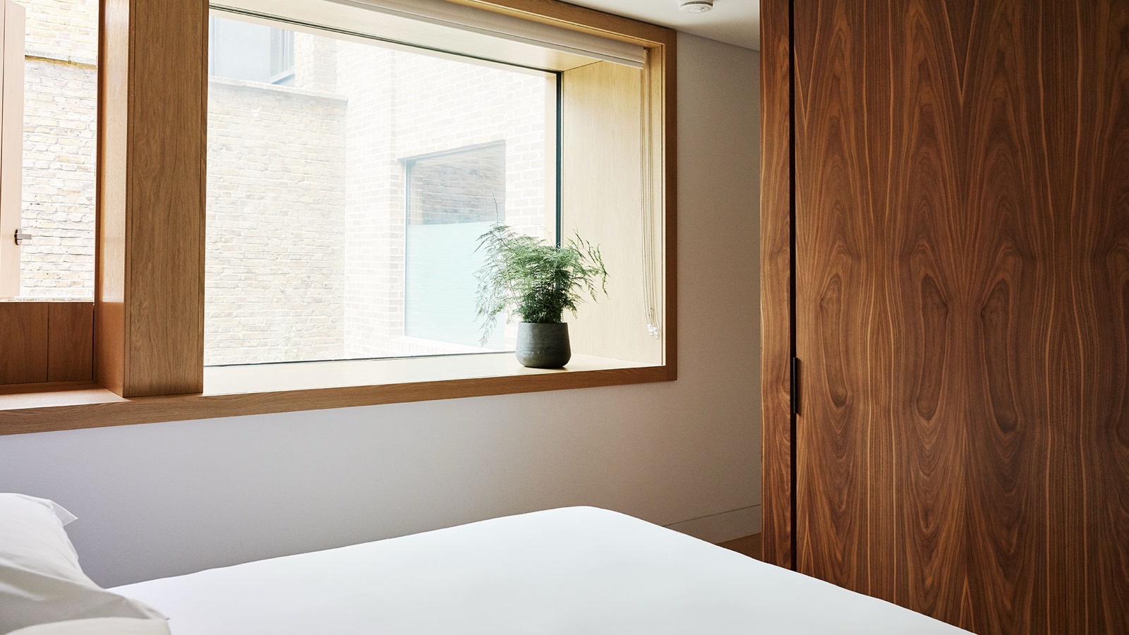Bedroom window seat and walnut wardrobe