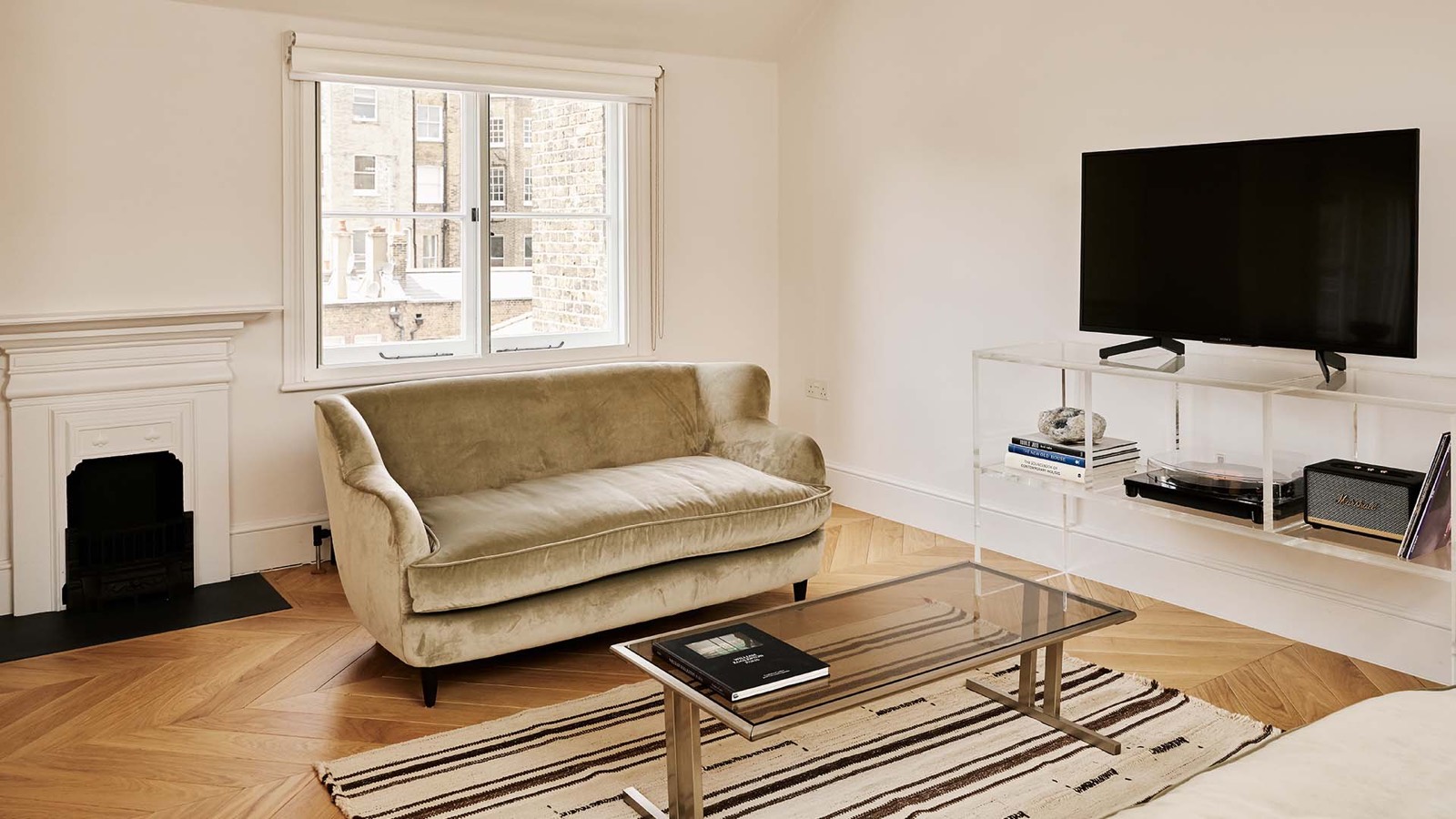 Sitting room with period fireplace and sash window