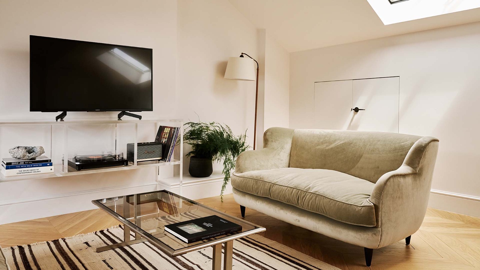 Velvet sofa beneath the skylight