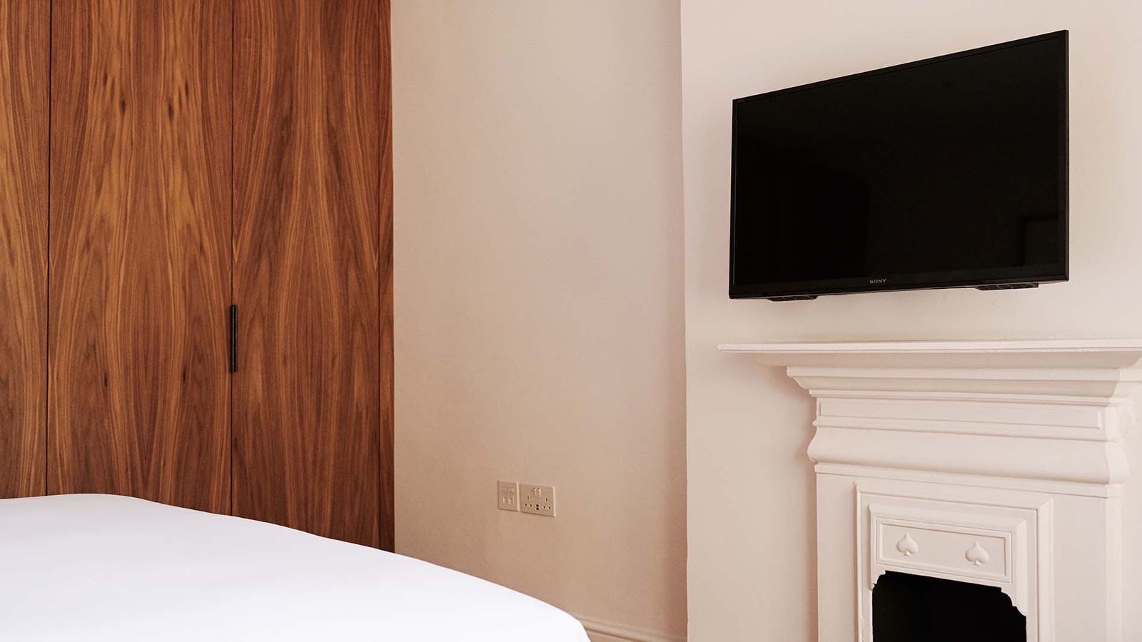 Painted fireplace and television in the bedroom