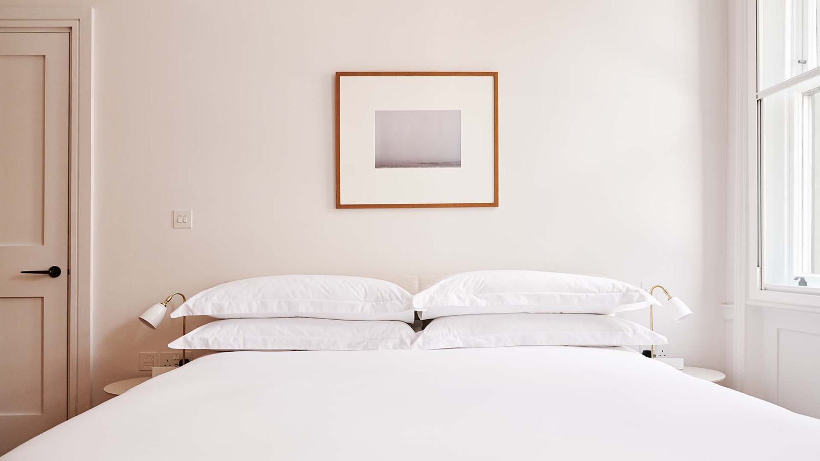 Super-king bed beneath a framed photograph