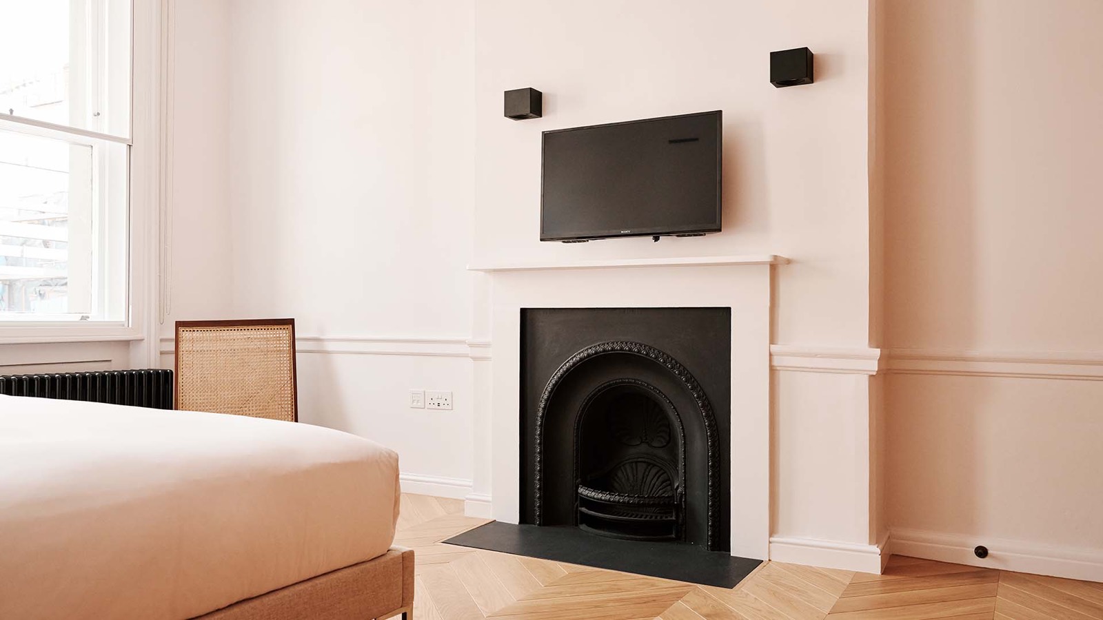 Cast-iron fireplace beside the bed