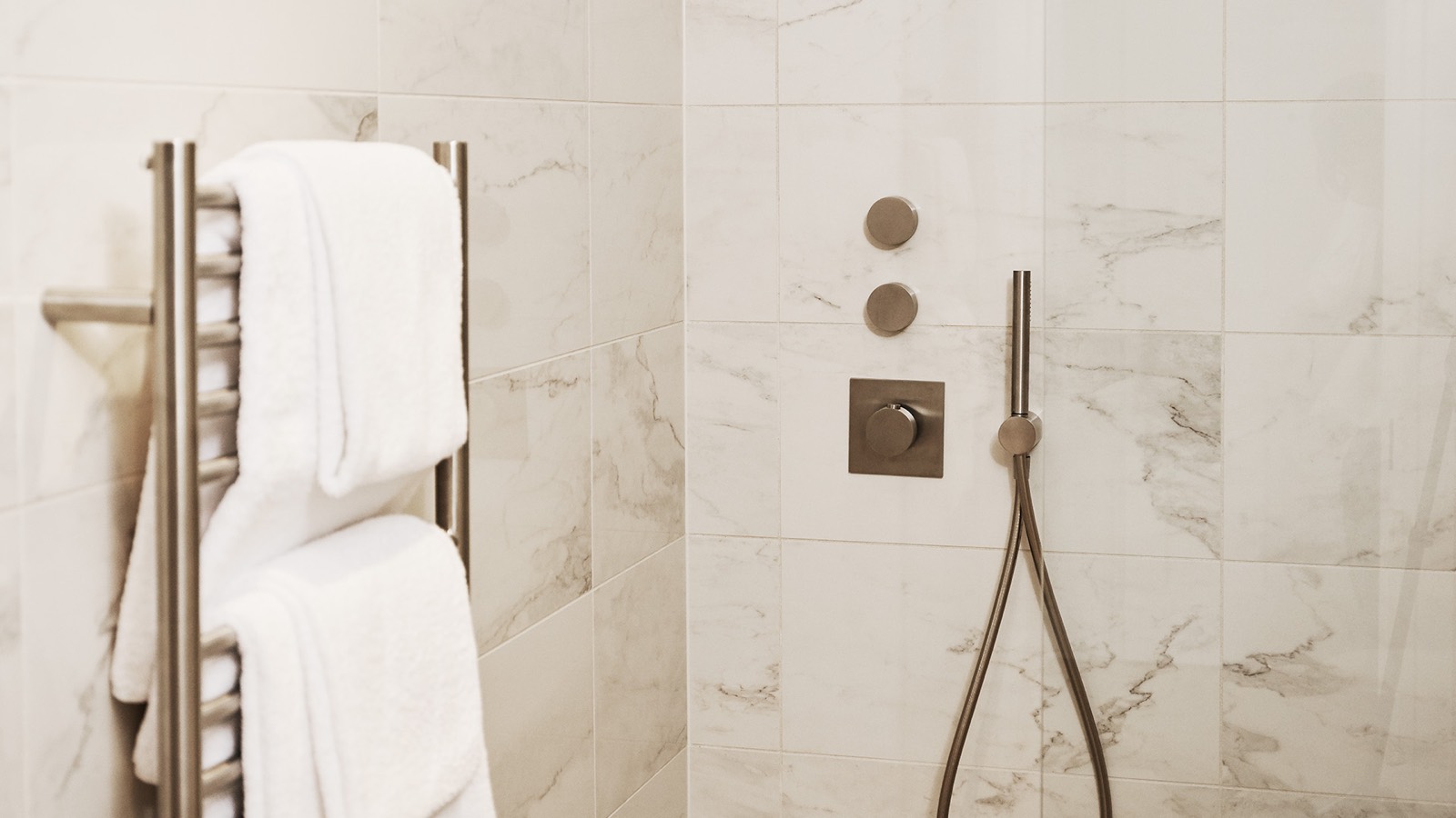 Walk-in shower with heated towel rail