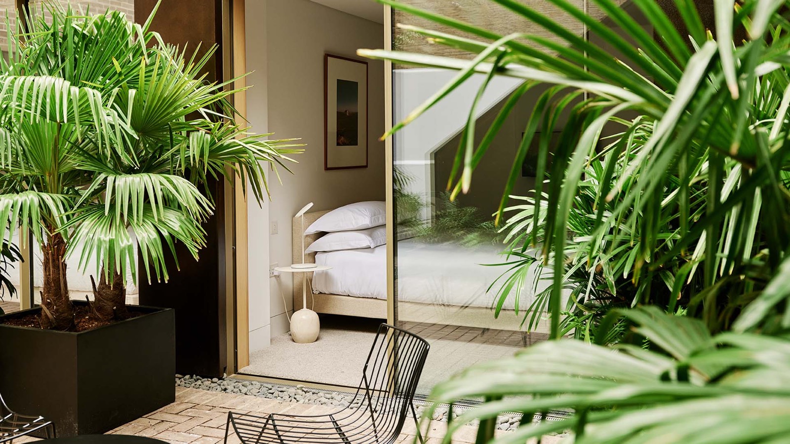 Bedroom seen from the courtyard through glass