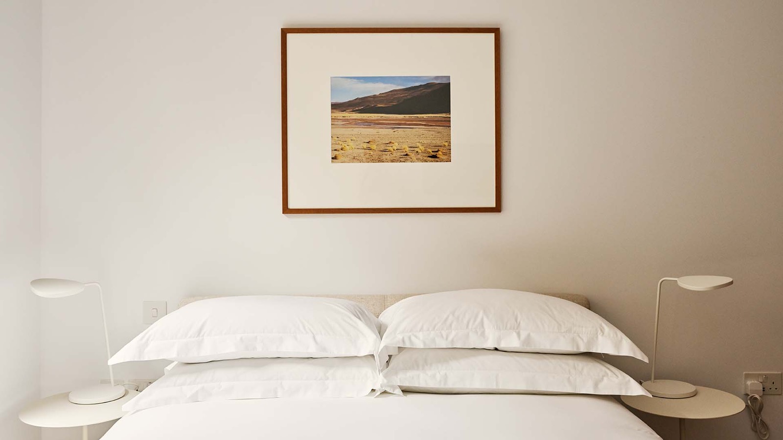 Further bedroom with paired bedside lamps