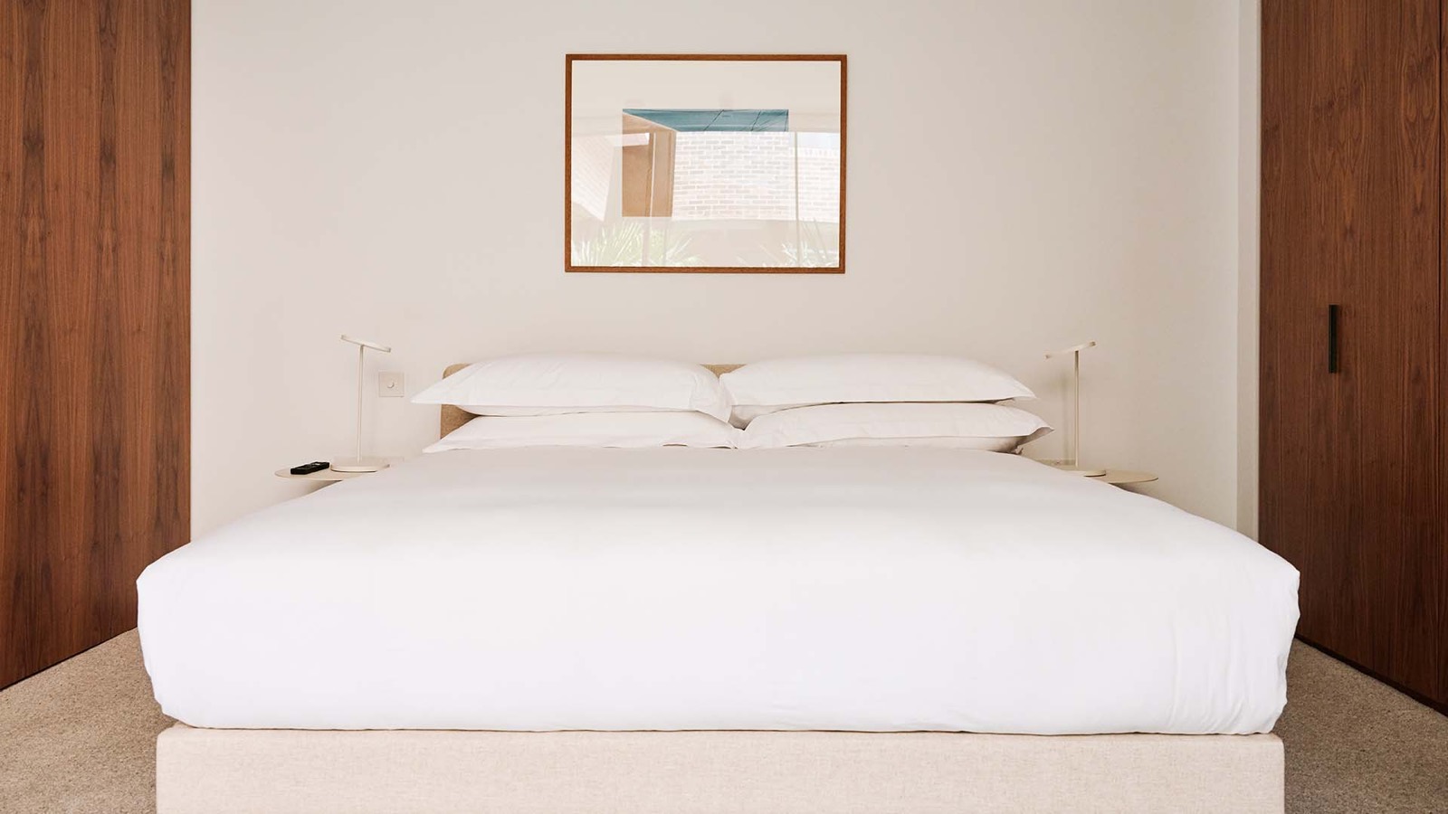 Bed set between walnut wardrobe doors